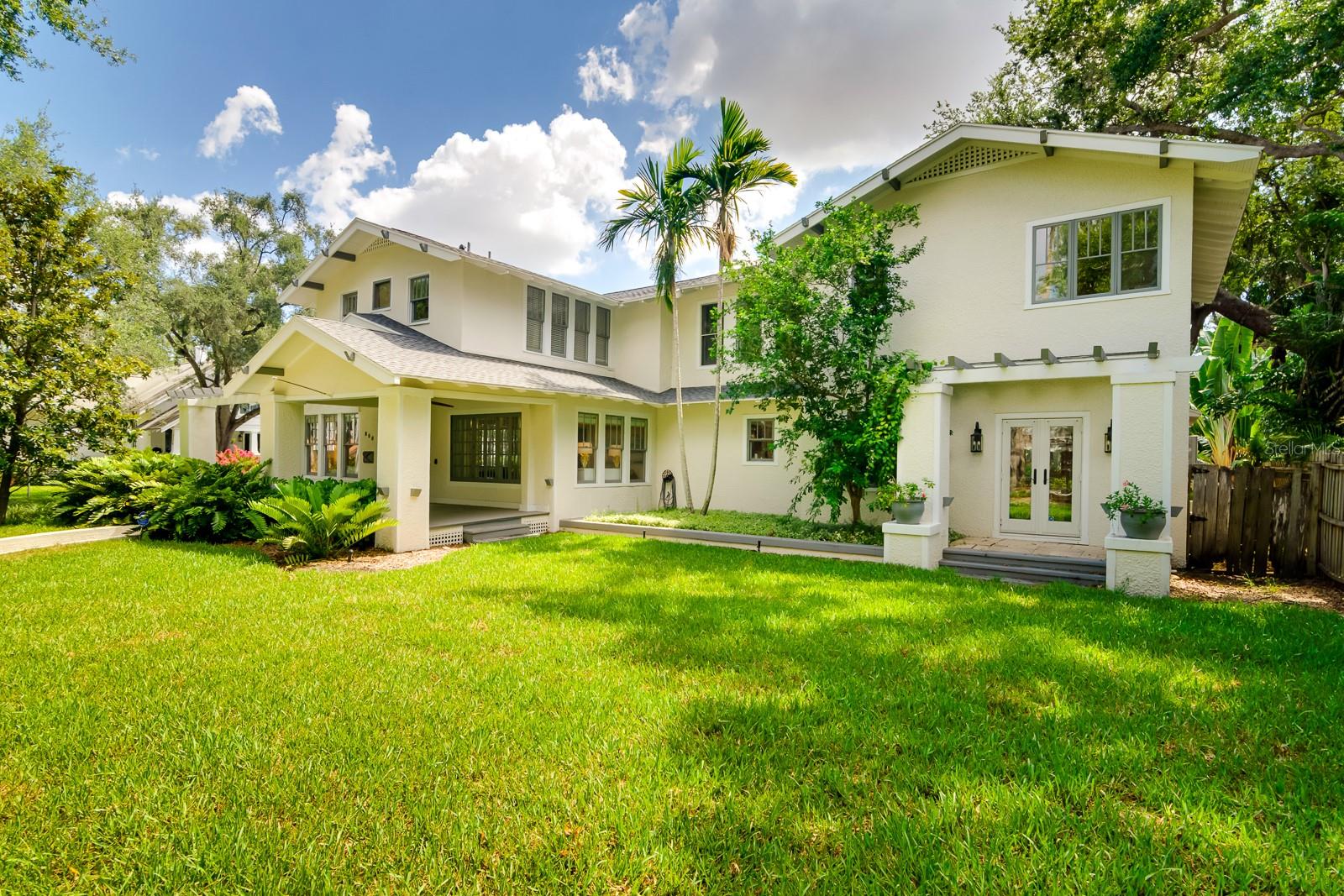 Just one block from Hyde Park Village’s boutique shops and fine dining, this spacious residence located on an oversized corner lot offers a perfect blend of historic charm and modern upgrades. The heart of the home is a gourmet kitchen with ample cabinetry and counter space, leading to a large family room and covered back porch with an outdoor kitchen and tropical swimming pool—ideal for entertaining. The first floor features formal living and dining rooms, a home office, and a guest bedroom. Wine enthusiasts will delight in the walk-in refrigerated wine room. Upstairs, the expansive owner’s suite boasts a custom walk-in closet and a beautifully appointed en-suite bath. Two more bedrooms, two baths, and a walk-in laundry room complete the second floor. Step outside to a tropical backyard oasis, featuring a freeform pool, stone waterfall, hot tub, and lush landscaping. A detached 2-car garage provides easy car access and includes a 752 sq ft guest apartment above, equipped with a living room, kitchenette, bedroom, and bath. With a total living space of 5,041 sq ft (main house: 4BR/4BA, 4,289 sq ft + guest apartment: 1BR/2BA, 752 sq ft), this home combines luxury, location, and lifestyle in one of Tampa’s most sought-after neighborhoods.