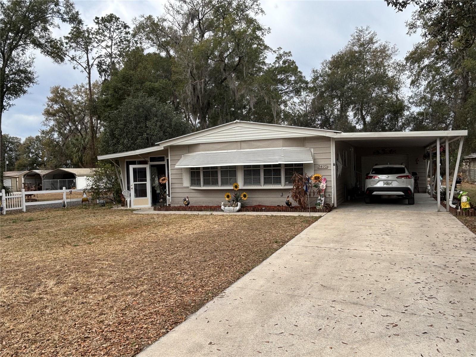2/2 home with enclosed Florida room and golf cart garage in a desirable community where you own the land. Open floor plan with abundant natural light, spacious bedrooms with walk-in closets, and vinyl/wood laminate flooring in main living areas. Enjoy the private backyard from the enclosed porch and experience easy Florida living in this wonderful community.