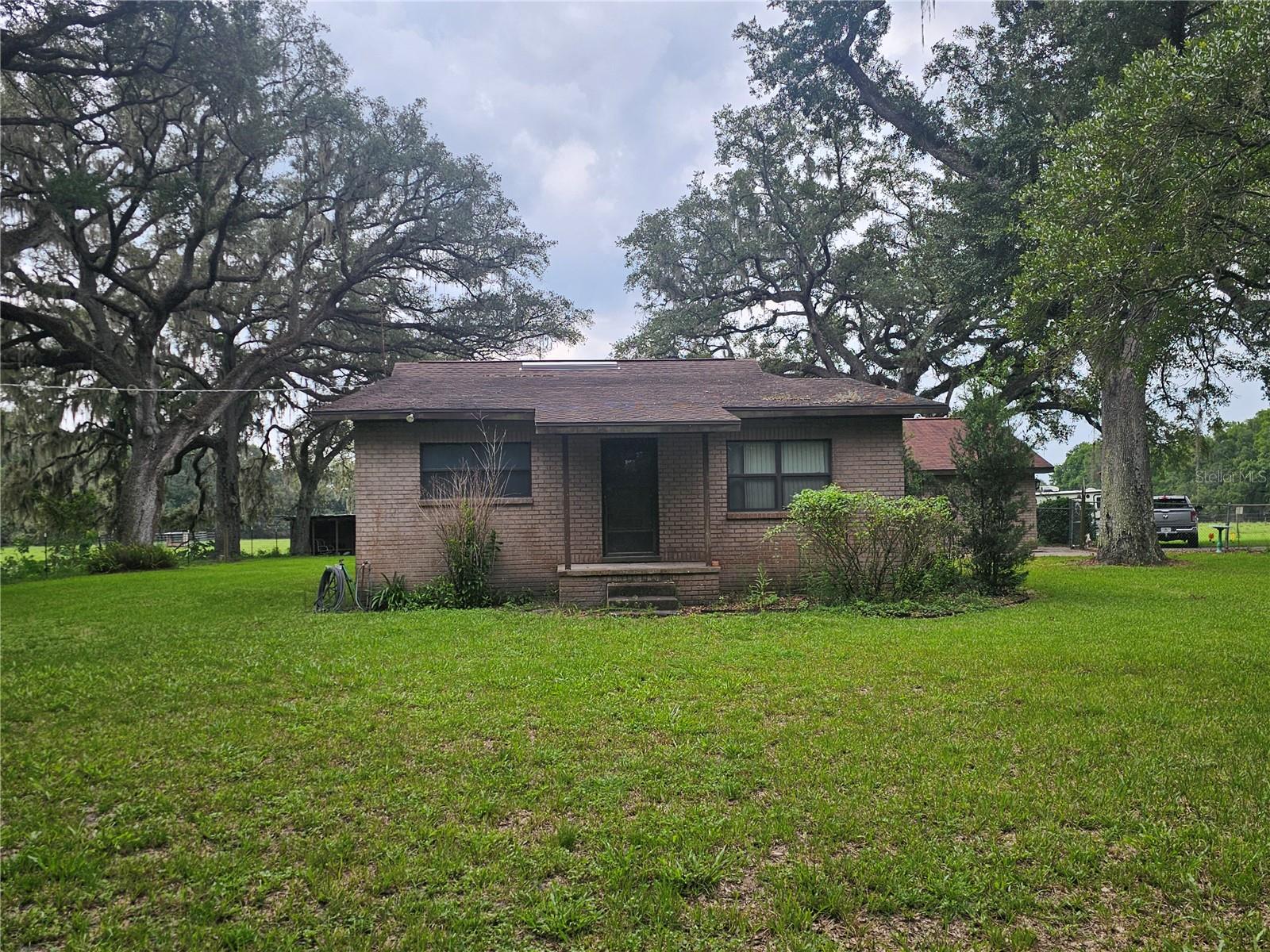 Beautiful 3-bedroom, 2-bathroom country home on a massive 2-acre lot with large oak trees! Detached 2 car garage and a shed in the backyard, This property offers peaceful, quiet country living with plenty of room for all your needs. Enjoy ultimate privacy beneath a stunning natural canopy while remaining incredibly close to Publix and I-75 for easy commuting. Situated in a rapidly growing area with brand-new stores and restaurants coming soon, this move-in-ready home offers an unbeatable blend of serene acreage and future convenience. No HOA or CDD restrictions! More pictures coming soon.