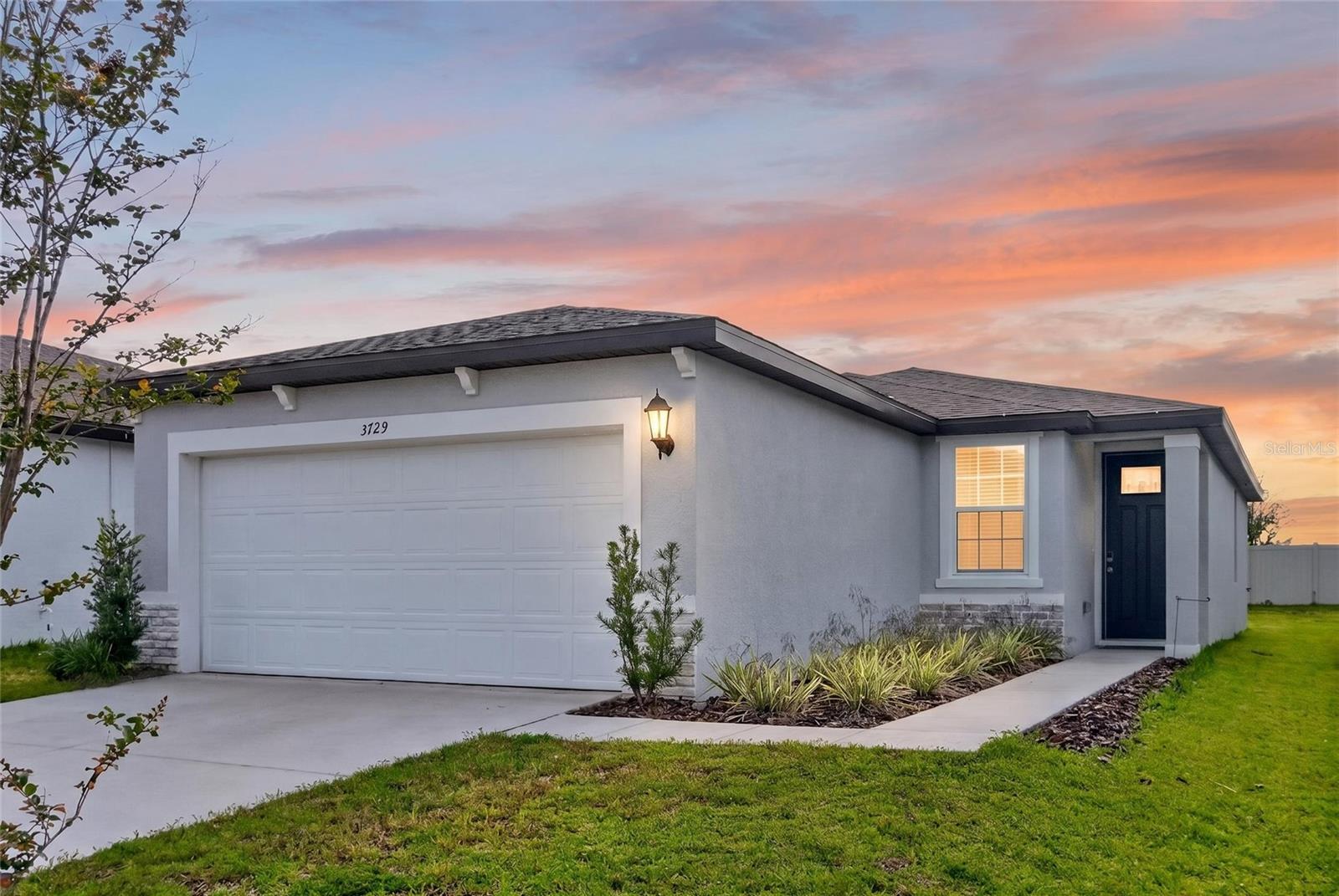 Assumable loan at 4.99%   This beautifully maintained home in the popular Park East subdivision offers modern design, open living spaces, and access to resort-style community amenities. Step inside to a bright and spacious open-concept layout featuring neutral tile flooring, recessed lighting, and abundant natural light. The kitchen is the heart of the home, complete with granite countertops, white shaker cabinetry, stainless steel appliances, and a large center island with bar seating; perfect for entertaining or everyday gatherings. The living and dining areas flow effortlessly together, creating a comfortable and functional space. The split-bedroom floor plan provides privacy and flexibility. The primary suite offers generous space, plush carpeting, and a well-appointed en-suite bath featuring dual vanities with granite countertops, a walk-in shower, and a large walk-in closet. Secondary bedrooms are well-sized and share a clean, modern full bath. Enjoy outdoor living with sliding glass doors that lead to a patio area which is ideal for relaxing, grilling, or customizing your outdoor space. Additional highlights include: interior laundry room with washer and dryer, 2-car garage.  Residents of Park East enjoy exceptional HOA amenities including a resort-style swimming pool with expansive paver deck and palm-lined lounging areas, a community playground, basketball court, open green space, and beautifully maintained common areas, offering something for everyone to enjoy. Conveniently located with easy access to major highways, close to the hospital, shopping, dining, and schools!