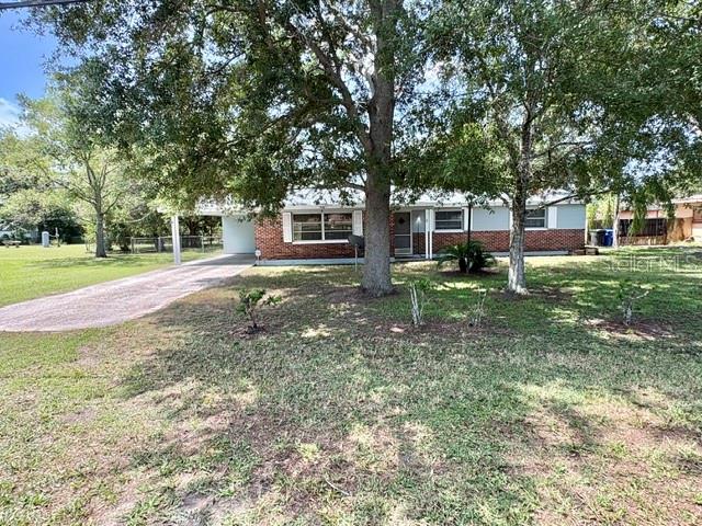 Virtually Staged. WOW—A Rare Opportunity on an Oversized Lot!
This solid block home is situated on a spacious lot of more than one-third acre, with no CDD and no HOA fees. The home is being sold AS IS and CASH ONLY.
A major improvement has already been completed: the roof was replaced in October 2025. Inside, the home features classic terrazzo flooring throughout most living areas, laminate flooring in the hall bathroom, and ceramic tile in the kitchen and dining room.
The galley-style kitchen opens to the dining room and includes a convenient closet pantry. Existing kitchen appliances are included but are not warranted. The dining room flows into a large living room, creating a comfortable space for everyday living and entertaining.
All bedrooms are generously sized. The primary bedroom includes an en-suite bathroom with a shower. Additional features include an attached, under-roof carport, a large screened lanai under the main roof, and an under-roof utility room with washer and dryer hookups.
Built in 1963 for the original owner, this home has been well maintained over the years and has never flooded due to storms or hurricanes.  The fully fenced backyard offers plenty of room for outdoor activities, pets, gardening, or future improvements. Two storage sheds are also included but are not warranted.
Bring your vision and make this spacious property your own. Schedule a private tour today!