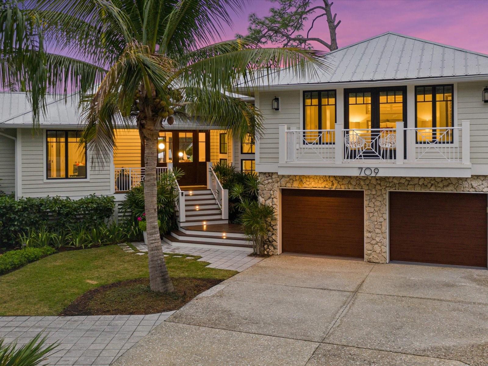 Immerse yourself in the pinnacle of luxury living within the prestigious waterfront community of Eagle Point Club, steeped in rich history. The experience begins along the journey of a private gated road which leads to an extraordinary masterpiece, The 2019 SRQ Home of The Year-Platinum Winner. Nestled on almost half an acre and surrounded by exotic landscaping, lies a grand estate home meticulously renovated to the highest standards by Edgewater, and inspired by the exquisite interiors curated by Holly Dennis Interiors. Upon entering, one’s gaze is captivated by the expansive open floor plan, lofty ceilings, contemporary kitchen, gorgeous DuChateau wood flooring, smooth textured ceilings and walls, and the allure of sliding glass doors leading to a pool embraced by lush landscaping. The living room is graced with a soaring cupola and an artist inspired gas linear fireplace, wrapped with an artistic concrete surround.  The kitchen was created with the thoughtfulness of entertaining and features a large multi-use island, superior cabinetry, quartz countertops, a paneled Subzero refrigerator, Wolf cooktop, Miele wall oven and coffee maker, and a built-in buffet for additional storage. The primary bedroom provides a scenic view of the backyard and features an elegant bathroom with dual sinks, glass shower, soaking tub, and a coveted Tahitian inspired outdoor shower. Both guest bedrooms offer ensuite bathrooms. The second floor provides a private setting for guests and features a full suite with a separate family room with a built-in bar and refrigerator, a bedroom with a private balcony, and a large bathroom. Benefit from impact windows and doors, ensuring safety and efficiency. This home is being offered furnished with a few seller exceptions. The home blurs the lines of indoors/outdoors with a fully stacking sliding door, which allows for one large indoor/outdoor space.  The resort space begins with the expansive, covered, and screened lanai with tongue and groove wood ceiling, Ipe decking, a full outdoor kitchen, and a pool worthy of a magazine. The large, saltwater pool features a heated spa, and flanking one end of the pool is an artistic wall with a pool shower, and the other end is a covered cabana. Boaters will appreciate the assigned boat slip #10, complete with a boat lift.  The Eagle Point amenities include a community dock on Roberts Bay, a 5-minute boat ride to the Gulf of Mexico (the only Gulf access for several miles each direction), tennis courts, and stunning grounds.  Dating back to 1911, Eagle Point residents are proud of the historic clubhouse where old fishing tales were shared. Residents’ overflow guests are allowed to rent the 3-bedroom cottage or 4-bedroom clubhouse, which is positioned across the street from the home. Acquaint yourself with the uncompromising luxury of Eagle Point Club living by arranging a private tour. Copy and paste the following link to view the luxury video: https://iframe.videodelivery.net/406434cbcd76779005249c955398fdeb