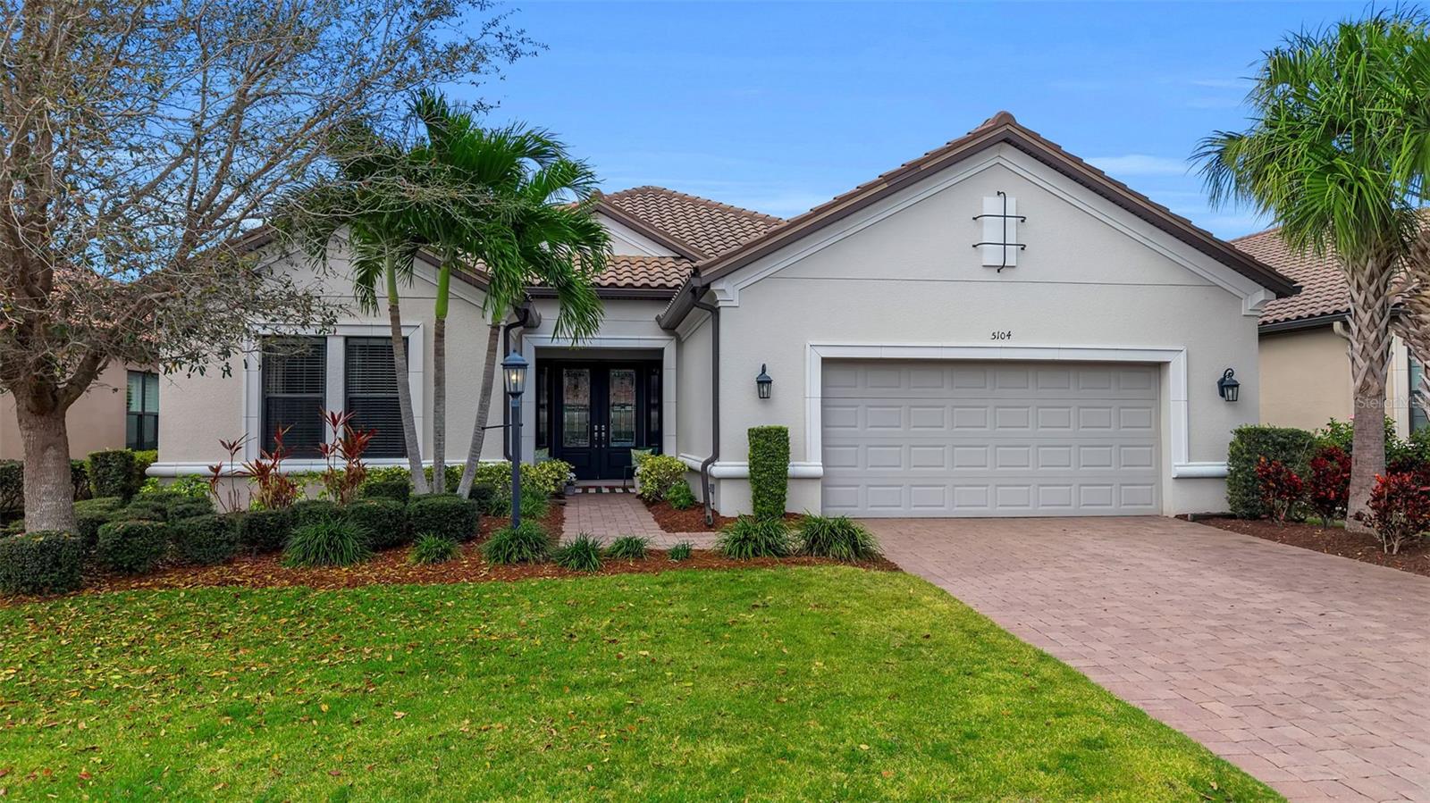 Wake up and play championship golf steps from your front door. Guard-gated and golf-deeded, Esplanade Golf & Country Club is Lakewood Ranch's most coveted private community — where every day feels like a five-star resort vacation. This stunning single-story Palazzio model offers 4BD/3BA + office, 3,170 sq ft of luxury living. Gourmet kitchen: GE Café appliances, Cambria quartz, gas cooktop, convection oven & prep-sink island — built for entertaining. Primary suite w/dual vanities, dual-head walk-in shower & custom closet. Private en suite in BR3. Escape to your serene, ultra-private backyard oasis — covered lanai, outdoor kitchen w/granite & beverage fridge, and plenty of room to add your dream pool. Crown molding, tray ceilings, custom closets & 3-car tandem garage w/epoxy floors. Then there's the lifestyle — tiki bar, resort pools, pickleball, state-of-the-art fitness, tennis & on-site dining. Extremely private. Exceptionally appointed. This is Florida living at its finest.