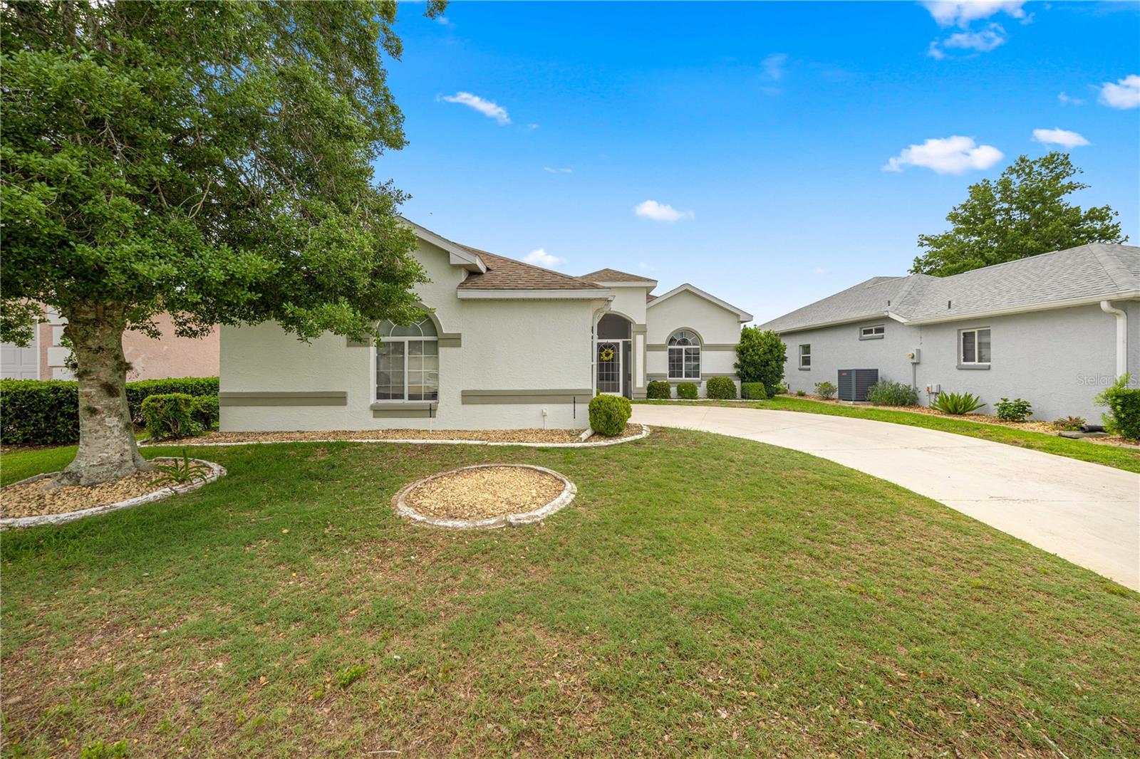 One or more photo(s) has been virtually staged. Welcome to 2379 NW 55th Avenue Road, Ocala, FL 34482, located in the highly sought-after 55+ golf course community of Ocala Palms. This beautifully maintained home offers just under 1,700 square feet of comfortable living space with a desirable triple-split floor plan designed for both privacy and functionality. Step inside to discover a spacious layout featuring granite countertops, stainless steel appliances, central vacuum, and a bright all-seasons Florida room perfect for enjoying Florida’s sunshine year-round, and YES its private with mature landscaping! The kitchen provides ample workspace and storage, while the brand-new washer and dryer are included for added convenience. The oversized primary suite serves as a private retreat with a generous bedroom, large walk-in closet, dual vanities, soaking tub, separate shower, and a versatile bonus sitting room that would make an ideal home office, reading nook, craft room, or private relaxation space. The guest bathroom has been thoughtfully updated with a handicap-accessible walk-in whirlpool jetted tub and modern vanity, offering both comfort and accessibility. Outside, the irrigation system helps maintain beautiful curb appeal year-round, while major updates include a hot water heater replaced in 2017, Roof 2013, and HVAC 2023. Living in Ocala Palms means enjoying an active Florida lifestyle with resort-style amenities including a championship golf course, clubhouse, fitness center, tennis courts, bocce courts, shuffleboard courts, library, crafting room, billiards room, ping-pong, outdoor Olympic-size swimming pool, and an indoor heated pool. Conveniently located near shopping, dining, medical facilities, and the World Equestrian Center, this move-in ready Ocala retirement home offers the perfect combination of comfort, recreation, and community living. If you’re searching for a home in Ocala Palms, a golf course community in Ocala, or an active adult lifestyle with outstanding amenities, this property deserves a spot at the top of your list.