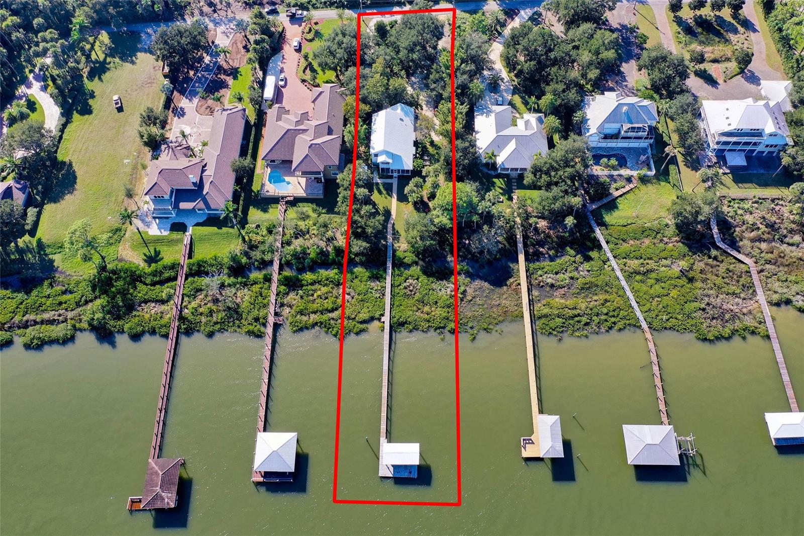 This beautiful, waterfront home is a Florida boater’s dream. Located on a gorgeously landscaped .7 acre lot, this property offers 100 feet of unobstructed views of the Intracoastal waterway, teeming with wildlife. Bring your boats, kayaks and SUPs and enjoy world class fishing in the backwaters of the lagoon or enjoy the peace and privacy of this park like-property and watch the world roll by. This attractive, hardie board home boasts cathedral ceilings, an open floor plan and picturesque views from nearly every room, including the ground floor Master bedroom, an upstairs sun room/loft and from multiple porches. The lovingly landscaped yard is a natural oasis, full of fruit trees and tropical plants and flowers. Additional highlights include a 220' dock w/ lift, water and electric, and a two-car, oversized garage and plenty of room and parking for all the toys. Come start your new life in this fantastic house and enjoy all that Florida has to offer. ;Water: City