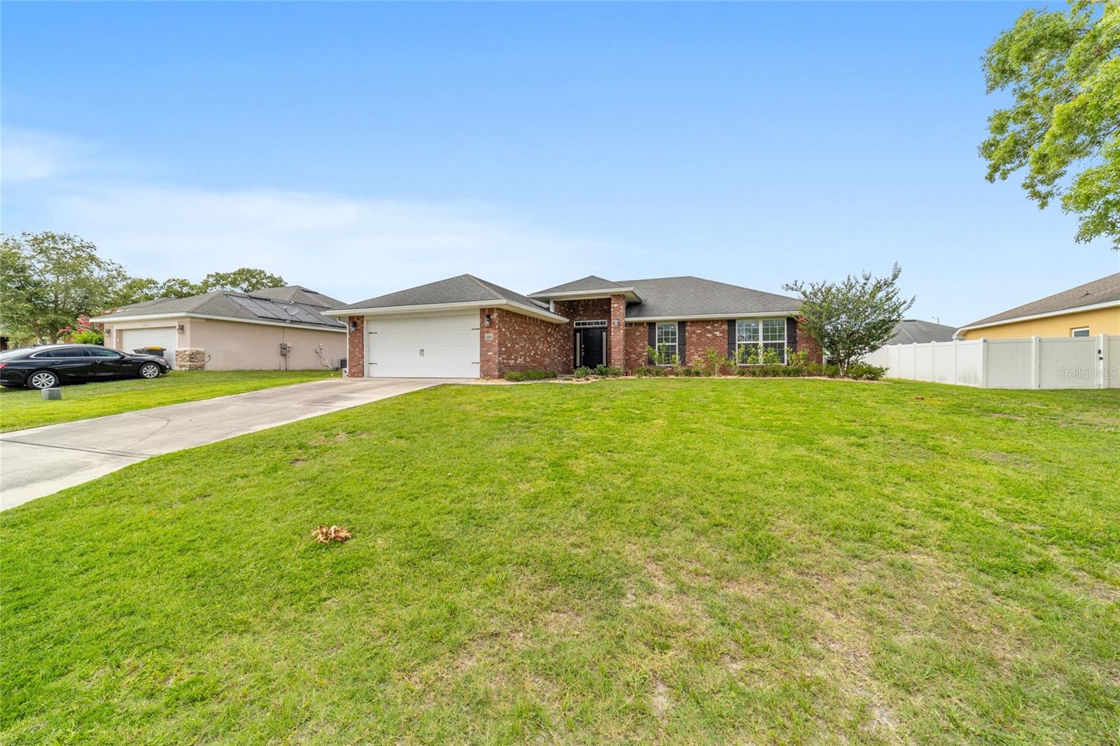 BRICK HOME + NO CARPET + LOW HOA! This beautifully maintained 4-bedroom, 2-bath home offers 1,762 square feet of living space and sits on a generous .27-acre lot, FULLY FENCED. Built in 2013, the home features a popular split floor plan, engineered vinyl flooring throughout, and a spacious layout designed for both everyday living and entertaining. The inviting living spaces flow seamlessly into the kitchen and dining areas, while the private primary suite offers a relaxing retreat away from the guest bedrooms. Enjoy your morning coffee or unwind in the evening on the screened 12x10 patio complete with a ceiling fan and views of the fenced backyard. Additional highlights include a tankless water heater installed last year, vinyl privacy fencing, a storage shed built in 2015, and an HOA fee of only $120 / year. If you've been looking for a move-in ready home with practical upgrades, outdoor space, and timeless brick construction, this one deserves a spot at the top of your list.
