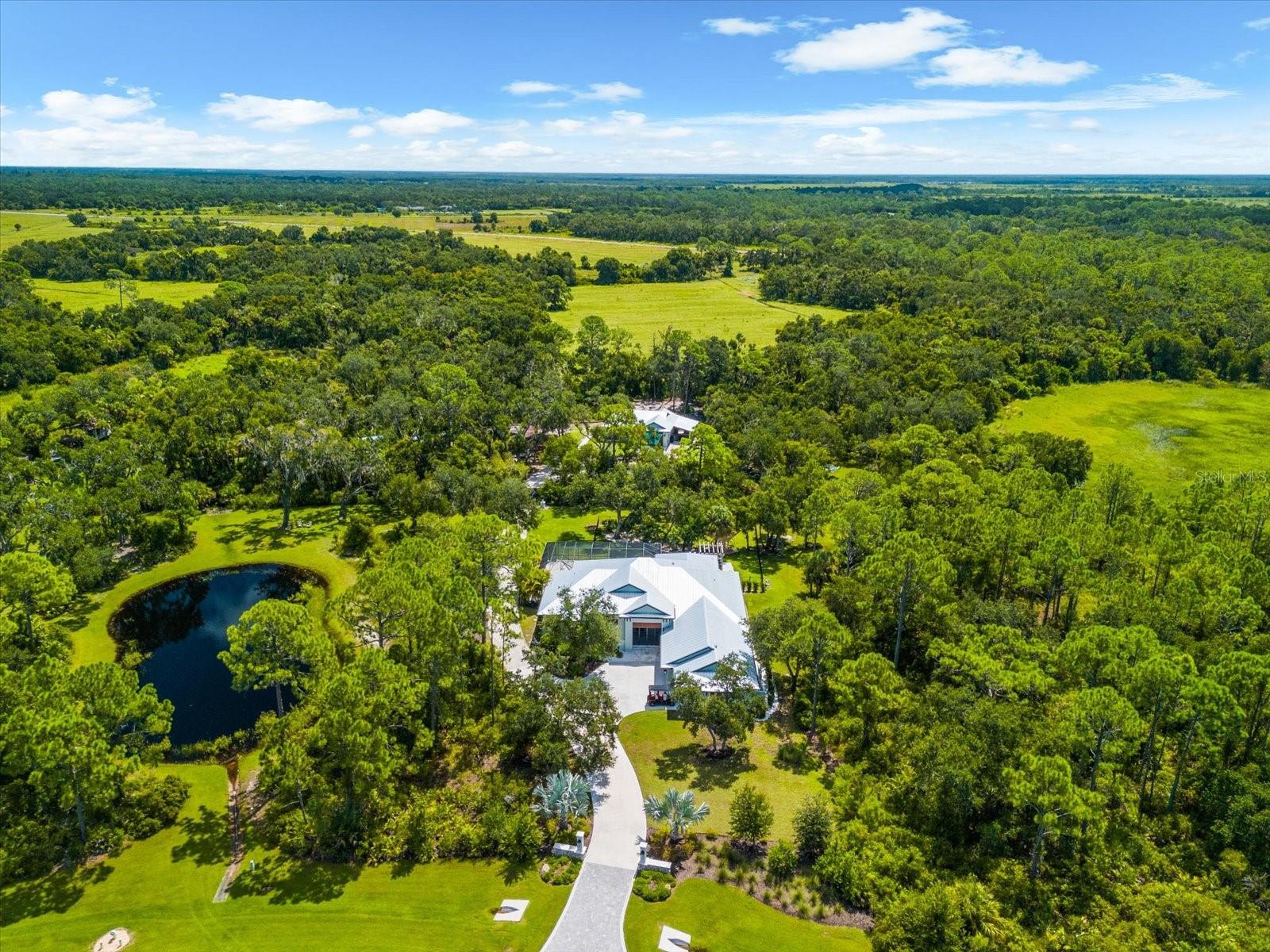 Under contract-accepting backup offers. Welcome to 10808 Leafwing Drive, a private 3.64-acre estate in Sarasota’s exclusive gated community, The Forest at Hi Hat Ranch. Designed and built in 2021, this custom-crafted residence—known as The David—is a rare opportunity to experience modern luxury seamlessly blended with the tranquility of nature. Every element of this home was thoughtfully designed to deliver sophistication, privacy, and the finest in Florida living. 

The main residence spans more than 5,500 square feet in total, with 3,352 square feet of air-conditioned living space centered around an open, airy floorplan. A dramatic 23-by-34-foot great room serves as the heart of the home, with soaring ceilings, a fireplace, and expansive glass doors that frame peaceful views of Lake Wood and the surrounding conservation land. The chef’s kitchen is equally impressive, featuring custom wood cabinetry, stone counters, top-tier appliances, walk-in pantry, and generous workspace for both everyday living and large-scale entertaining. There are a total of 4 bedrooms - 1 is currently used as an office which has an adjacent bathroom.

The primary suite was designed as a private retreat, complete with a spa-inspired bath featuring a soaking tub, oversized walk-in shower, dual vanities, and a spacious custom closet. Two additional guest suites with walk-in closets and en suite baths lend comfort and privacy. A versatile study with its own walk-in closet provides flexibility as a home office, library, or additional bedroom.

Enhancing the property’s versatility, a detached casita offers an additional 600 square feet with a private bath and kitchenette—perfect for extended family, long-term guests, or multigenerational living.

Outdoor living takes center stage in this estate, with a heated saltwater pool featuring a sun shelf, fiber optic lighting, and an integrated spa. The expansive screened lanai with summer kitchen, outdoor dining, and multiple lounge areas creates a seamless indoor-outdoor lifestyle. Mature landscaping, irrigation system, and private fencing further enhance the serene setting.

Additional features include a four-car garage with carport parking, golf cart and RV accommodations, storm protection, whole-house water filtration and reverse osmosis systems, and energy-efficient design throughout.

Beyond the property, residents of The Forest at Hi Hat Ranch enjoy the rare combination of seclusion and convenience. Just minutes from downtown Sarasota, world-class beaches, fine dining, golf, and cultural venues, this estate provides both privacy and access to everything that makes Sarasota one of Florida’s most desirable destinations.

10808 Leafwing Drive is more than a residence—it is an estate of distinction that offers timeless craftsmanship, luxurious amenities, and an unparalleled Florida lifestyle.