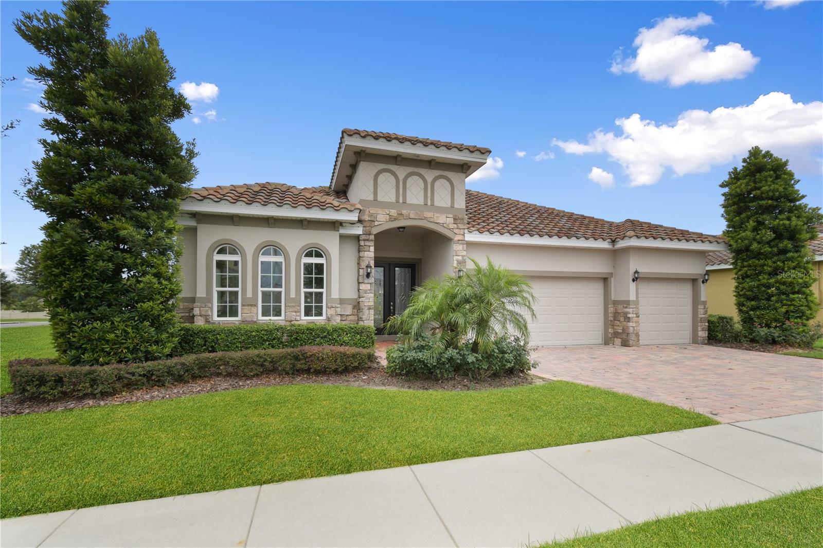 Open Concept Floor Plan, Decorative Glass Double Door Entry with Tray Ceiling in Foyer, Coffered 9 Box Ceiling w/ Crown Molding in Living Room, Double Tray Ceiling w/ Crown Molding & Chairs & Squares in Dining Room, Large Fireplace Built-In Feature with Stone Facade in Living Room, 8' Triple Hidden Sliding Glass Doors Open to an Extended Lanai complete with Summer Kitchen Pre-Plumb. Entire Home has Faux Wood-Look 6x24 Grove Villa Ceramic Tile, Upgraded 42" Linen Shaker Style Cabinets with Crown Molding. Center Island with 3cm Granite Counter Tops, Stainless Steel Kitchen Appliance Package, Large Walk-In Pantry, 5.25" Baseboards throughout. Master Bedroom has Large Bay Window Feature that adds lots of extra floor space and light. Shower Enclosure in Guest Bath #3, Upgraded Tile in Master Bath and Guest Bath #3 and Two Inch Faux Wood Blinds on all Windows. Home includes Zip System Sheathing for added Weatherization, R-38 Attic Insulation, 16 Seer HVAC and Double-Pane Insulated Windows for added Energy Efficiency. Exterior features include Upgraded Elevation C with Stone, Canned Lights on Soffit, Coach Lighting, Paver Drive & Walkways, Mature Designer Landscaping and Irrigation.Quiet, Bedroom Community, conservation views, close to major lakes & 11 golf courses, minutes to the Lakeridge Winery, Historic Howey Mansion and Mission Inn Resort. Close proximity to the Turnpike and centered between Mt. Dora, Tavares, Clermont and Orlando. LAWNCARE IS INCLUDED IN THE RENT!