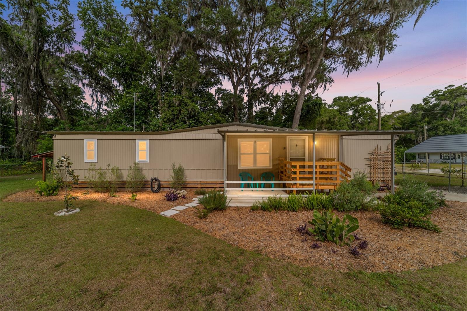 Tucked away on nearly half an acre of beautifully fenced and landscaped property in Belleview, this charming and thoughtfully updated home offers the perfect blend of comfort, style, and functionality. Featuring 1 spacious bedroom and 1 and a half bathrooms, the interior has been recently remodeled with modern finishes while maintaining a warm, inviting feel throughout.
The well-appointed layout includes a bright living space, an updated kitchen, and a convenient utility room located in the screened back porch—adding both practicality and easy access for everyday living. Step through your sliding glass doors to your screened in sanctuary or head outside to enjoy the expansive yard, ideal for entertaining, gardening, or simply relaxing in your own private retreat. An outdoor shower adds a unique touch, perfect after a day spent in the yard.
The detached garage/workshop provides excellent space for hobbies, storage, or projects and room for guests to hookup their RV to 30amp power and separate septic tank, making this property as practical as it is charming. Fully fenced and gated, with plenty of room to spread out and thoughtful upgrades already in place, this home is a rare find offering both privacy and versatility in a peaceful Belleview setting. Furnished and move in ready! *New appliances, new roof on shed and garage. Well and septic replaced by previous owner and whole home rewired in 2019. The seller also owns an additional 0.23-acre parcel directly to the west, which is available for purchase at an additional cost.