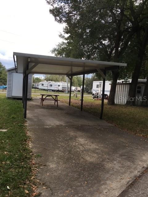 Vacant lot for rent. Bring your RV for long term rental of a pull-thru lot with a carport, patio slab, and storage shed. Located in the gated community of Clarcona Resorts with activities such as swimming pool, basketball court, shuffleboard and monthly dinners for a few dollars. 30+ minutes from Disney. Close driving distance to I4, 414 and the 429.