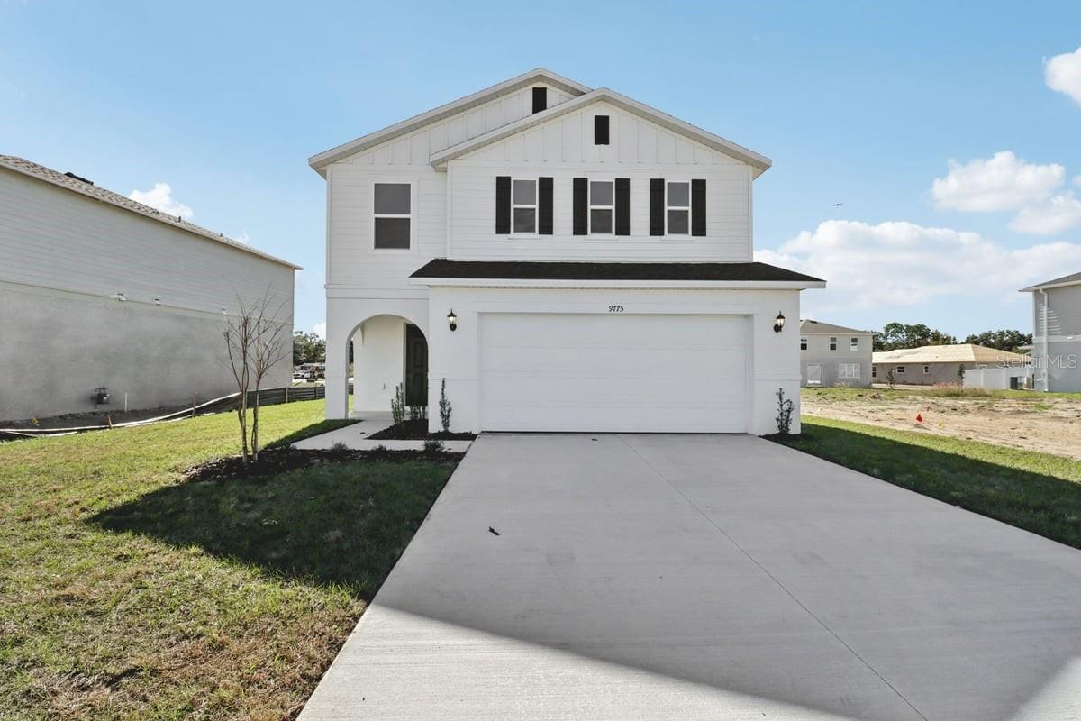 This inviting, two-story home showcases an open floor plan with tile flooring and 9-ft. first-floor ceilings. The modern kitchen boasts Whirlpool® stainless steel appliances, a peninsula, granite countertops, a Moen® faucet, a Kohler® sink and 36-in. upper cabinets. A convenient laundry room with garage access is located downstairs. Upstairs, the primary suite features a tray ceiling, walk-in closet and connecting bath that offers granite countertops, a dual-sink vanity, linen closet and walk-in shower with tile surround. Enjoy outdoor living on the covered back patio.