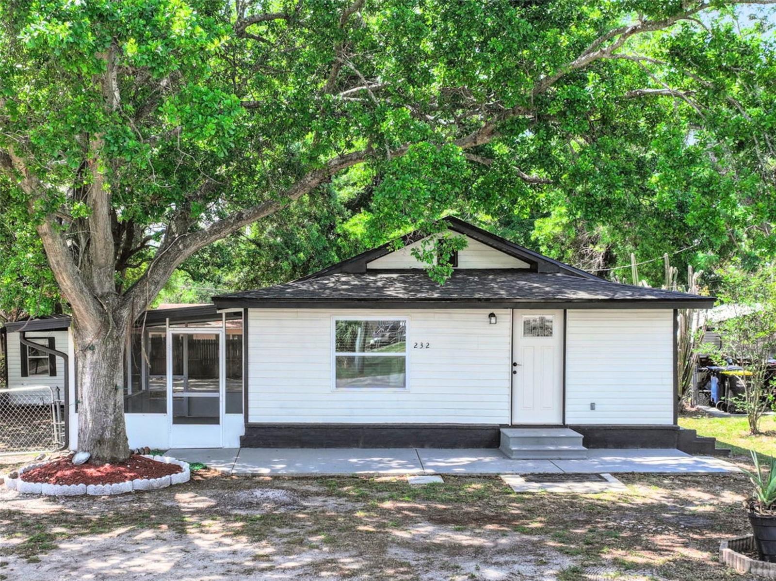 One or more photo(s) has been virtually staged. Tucked beneath a canopy of mature trees, this property with NO HOA offers a naturally cool and shaded setting year-round—creating a peaceful, private atmosphere with lush greenery and true nature-inspired living. The surrounding trees not only enhance privacy but also help maintain a refreshing temperature, making the outdoor space feel like your own serene retreat.

Inside, the home opens up to a bright, airy layout enhanced by recessed lighting, luxury vinyl flooring, and brand-new stainless steel appliances. The open floor plan flows seamlessly into the living area, where sliding glass doors lead to a fully enclosed, cemented patio, creating the perfect extension of indoor-outdoor living—ideal for entertaining, relaxing, or creating your own private retreat.

Both bathrooms have been fully updated with modern finishes, and the home features its own dedicated laundry room for added convenience. Major systems have already been taken care of, offering peace of mind with a brand-new 2026 roof, 2021 A/C, 2024 water heater, updated electrical, new plumbing, new windows, and new doors with blinds installed throughout.

Step outside and the possibilities expand even further. The oversized lot is designed for lifestyle and versatility—whether it’s parking boats, jet skis, RVs, or other recreational toys, there’s room for it all. A large workshop with electricity opens the door to something more: a potential income-producing studio or future ADU conversion. Paired with an additional shed, this space is ideal for buyers with vision—whether for business use, creative projects, or passive income opportunities.

Located in the heart of Auburndale, an area known for its charming small-town feel and access to the scenic Lake Ariana—a local favorite for boating, waterskiing, and fishing—this home offers more than just a place to live, but a lifestyle to enjoy.

Zoned for nearby schools including Auburndale High School, Stambaugh Middle School, and Lena Vista Elementary School, the location balances convenience with community appeal.

Whether you’re looking for a move-in-ready home, space to grow, or an opportunity to create additional income, this property delivers flexibility, upgrades, and lifestyle—all in one.
