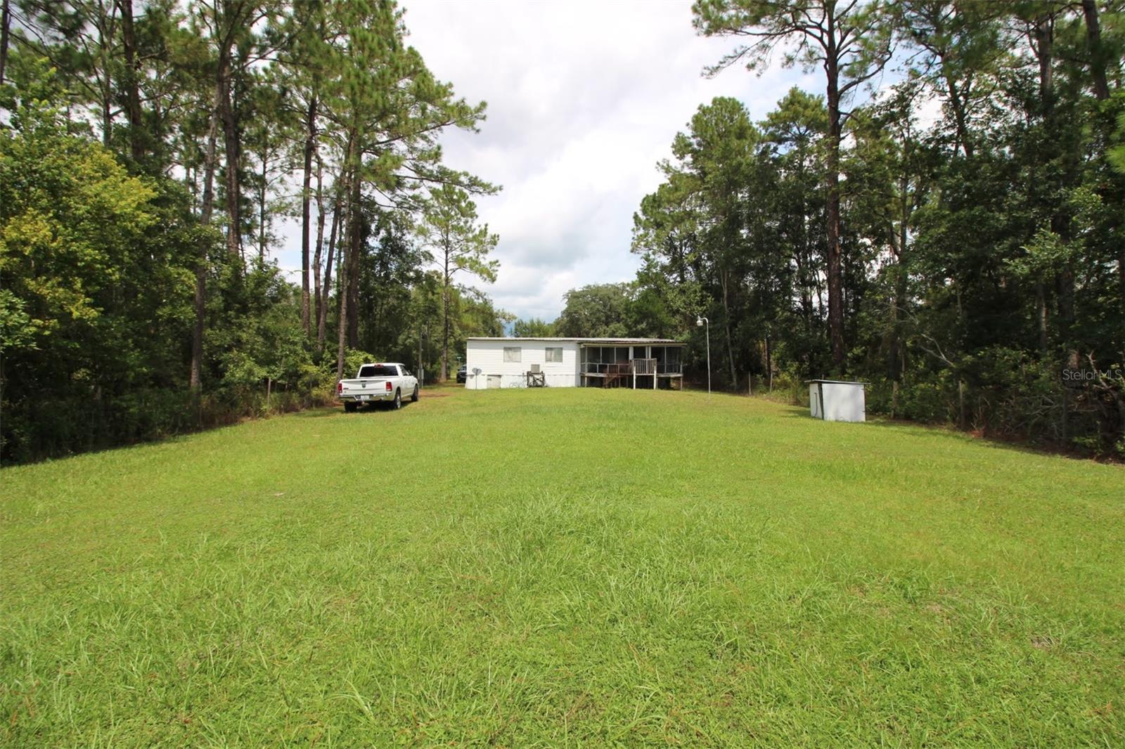 This cozy mobile home is the perfect getaway, offering peaceful lakefront living with stunning views. Step outside onto the screened porch and take in the serene surroundings. You can start your mornings with a breathtaking sunrise over the water, and end your evenings watching the sky blaze with color as the sun sets.

The property is fully fenced, creating a private and secure space for you to relax and enjoy the quiet atmosphere. With direct lake frontage, just walk out of your back door and enjoy swimming, fishing, or simply dipping your toes in the water. This home is a tranquil retreat where you can truly unwind and connect with nature.

CASH ONLY, NO RENT TO OWN, NO OWNER FINANCING