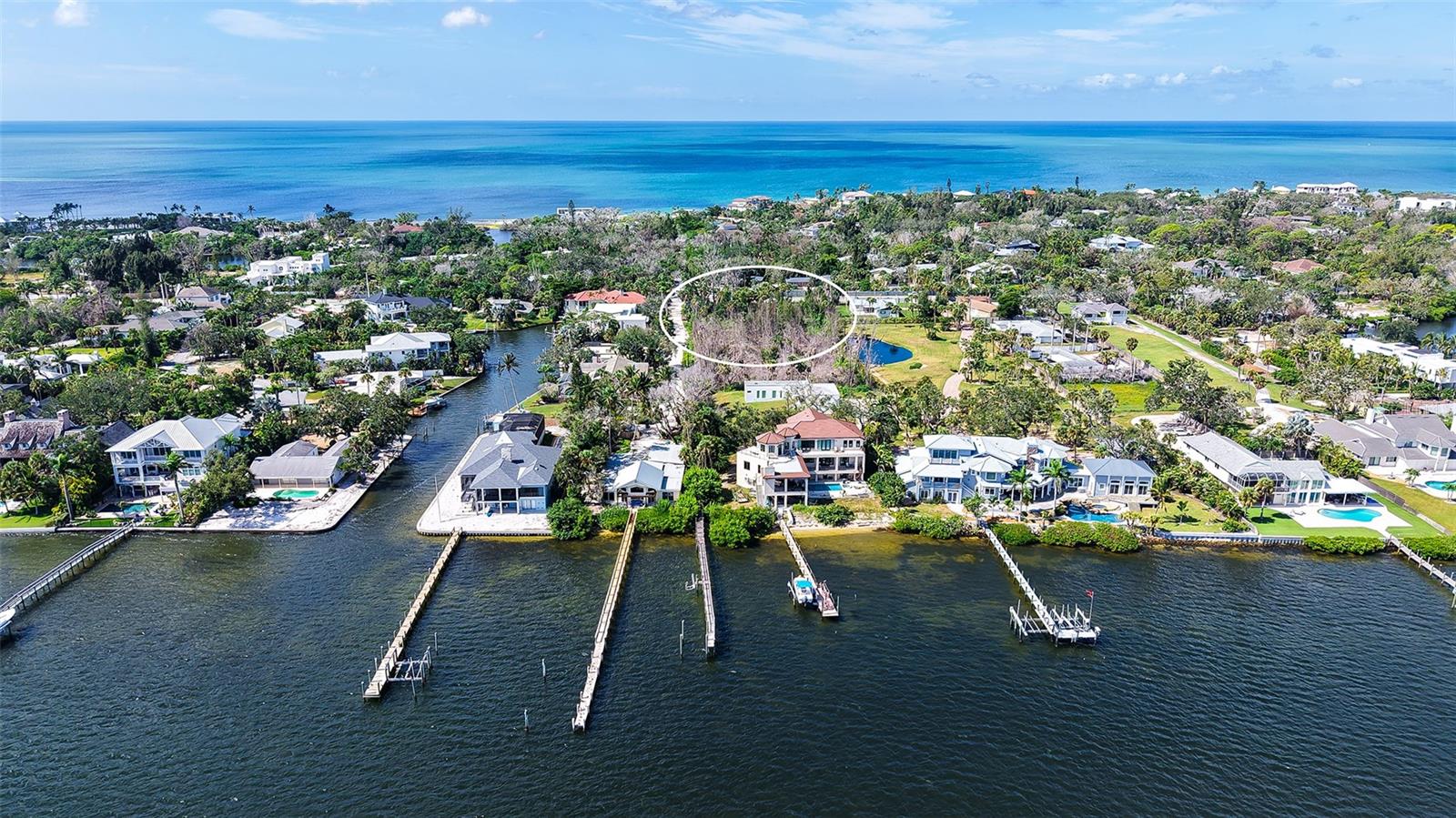 ….. One Acre of Siesta Key vacant land with Bay access is almost impossible to find! Here it is, your gateway; the ideal canvas for your dream property, a homesite simply unique in its size and its location, offered at an exceptional price. This rare piece of land is just 0.7 miles south of Stickney Point bridge, across from the renowned Sanderling Club. With 175 ft of street frontage and a depth of 244 ft along Port Lane, this expansive parcel (± 1 Acre/42,677sq ft) gives you a generous building footprint, the coveted opportunity of privacy, of serenity in the middle of it all. Build your custom dream home and still have plenty of room to design your private driveway and your tropical Florida yard. Take a short stroll to your private dock which extends 235 ft into the bay waters and is capable of docking a boat, jet skis, and kayaks. From there you are just a short boat ride away from the blue waters of the Gulf. You will enjoy how much ‘Little Sarasota Bay’ is Loving Life since Midnight Pass opened naturally, boasting a visible improvement of water clarity & marine life. Not to forget that All of Siesta Key is right at your front door, the famous powdery Beaches, Crescent & Point of Rocks beach, Turtle Beach, its vibrant villages with its shops, Bars & Restaurants. Take this great opportunity to build your private beach retreat, Custom builders in the area are well-versed in designing elevated, contemporary, and Key West–inspired homes to complement this exceptional setting. Bay and/or Gulf Views possible depending on design of home. Call today for a showing and additional information.
Lot features: lot has been partially cleared, 2 wide paths to discover the property populated with Palm Trees & some Australian Pine clumps, typical Florida underbrush, no elevation change throughout the parcel, no wetland, 20ft wide easement to dock. Survey, Topographic map and Soil Test are available.