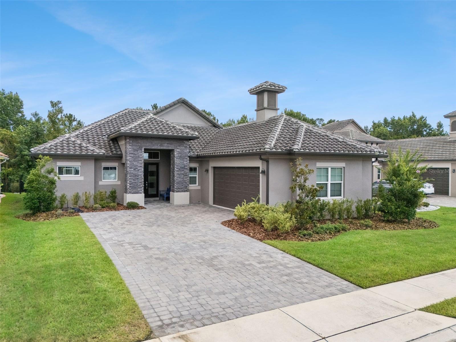 Welcome to 2730 Willingam Drive, an exceptional 4-bedroom, 3.5-bath home located in The Greens at Providence, one of Davenport's most sought-after gated golf communities. Built in 2020 and situated on a premium 0.23-acre homesite with peaceful greenbelt and wooded conservation views, this beautifully maintained residence offers 2,293 square feet of thoughtfully designed living space that blends modern elegance, comfort, and functionality. From the moment you arrive, you'll appreciate the home's impressive curb appeal featuring a paver driveway and walkway, attractive stucco exterior, tile roof, and manicured landscaping. Inside, the open-concept floor plan is enhanced by high ceilings, crown molding, tray ceilings, abundant natural light, and quality finishes throughout. The spacious family room serves as the heart of the home and features an elegant cove ceiling, and oversized double-width sliding glass doors that open to the patio, creating the perfect indoor-outdoor living experience. The gourmet kitchen is designed to impress with quartz countertops, a large center island, pantry closet, stainless steel appliances, built-in oven, cooktop with drop-down exhaust, microwave, dishwasher, disposal, and a comfortable dining area for everyday meals and entertaining. The primary suite is conveniently located on the main floor and offers a private retreat with a spacious walk-in closet and luxurious en-suite bath. A desirable split-bedroom layout provides privacy and flexibility for family members and guests. Additional features include a living room/dining room combination, solid surface counters, ceramic tile and carpet flooring, covered front porch, rear patio, thermostat-controlled comfort, and a two-car garage. Enjoy tranquil views of mature trees, conservation space, and natural greenbelt areas from your backyard, offering a peaceful setting rarely found in newer construction homes. Residents of The Greens at Providence enjoy access to an outstanding collection of resort-style amenities within the award-winning Providence master-planned community. This 24-hour guard-gated community spans more than 2,200 acres of beautifully maintained grounds, scenic ponds, walking trails, and conservation areas. Homeowners have access to a resort-style swimming pool, clubhouse, fitness center, tennis courts, playground, dog park, championship golf course, on-site restaurant, recreation facilities, and beautifully landscaped common areas, all designed to support an active and enjoyable lifestyle. Ideally located near Interstate 4, Providence offers convenient access to Orlando's world-famous attractions including Walt Disney World, Universal Orlando Resort, and SeaWorld, while also being just minutes from shopping, dining, and entertainment at Posner Park. Whether you're looking for a primary residence, vacation home, or investment opportunity, this move-in-ready property offers the perfect combination of luxury, convenience, and Florida living.