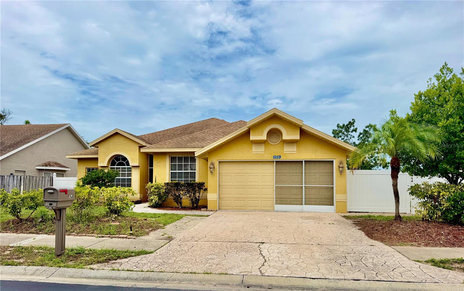 Welcome to 1959 Wood Trail St, Tarpon Springs, FL 34689, a beautifully maintained 4-bedroom, 2-bath home in the desirable gated community of Forest Ridge. Situated on an oversized corner lot, this almost 2,000 sq ft home offers thoughtfully designed living space with a bright and welcoming atmosphere. The home features a combination of ceramic tile flooring and brand-new luxury vinyl plank flooring, providing both durability and style throughout the living spaces, as well as an attached 2-car garage. The split-bedroom layout provides privacy and functionality, with the primary suite privately located on one side of the home and three additional bedrooms on the opposite side. The spacious living and dining areas flow seamlessly into the kitchen and family room, creating the perfect setting for everyday living and entertaining. The primary suite features a walk-in closet and an en-suite bathroom with dual sinks, a separate shower, and a private water closet with a separate toilet room. The additional three bedrooms are conveniently located near the second bathroom with a shower, providing comfort and convenience for family members and guests. Step outside to the screened rear porch with a comfortable seating area, the perfect place to enjoy your morning coffee, relax in the evening, or entertain friends and family. The porch overlooks the spacious backyard featuring a vinyl privacy fence, a large grassy area, and a storage shed, offering plenty of room for pets, play, gardening, or outdoor activities. The attached two-car garage provides additional storage and convenience. Located in the sought-after gated community of Forest Ridge, residents enjoy mature landscaping, low HOA fees, and a convenient location just minutes from historic downtown Tarpon Springs, the world-famous Sponge Docks, Fred Howard Park, Sunset Beach, shopping, dining, golf courses, and beautiful Gulf beaches. With easy access to US-19, Clearwater, Tampa, and surrounding areas are within reach. Recent updates include a brand-new A/C system, fresh interior paint, new luxury vinyl plank flooring, and a freshly painted garage floor, making this home move-in ready and offering peace of mind for years to come.