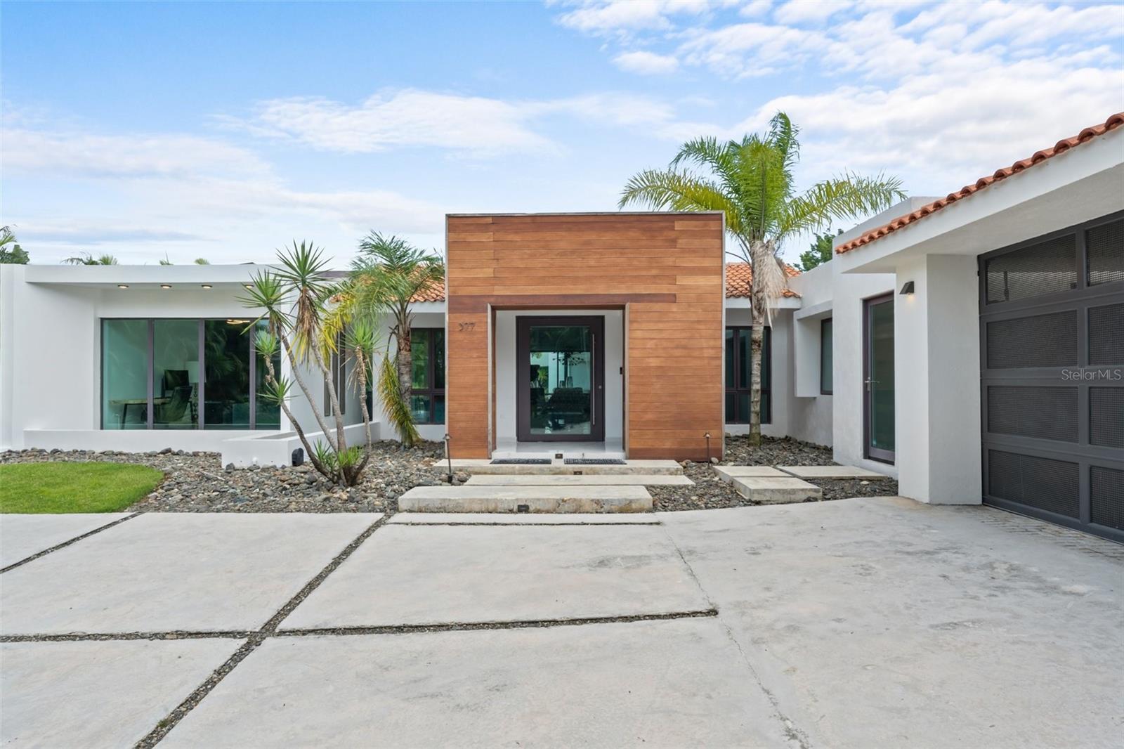 Located within the exclusive gated community of Dorado Beach East, this elegant single-level residence sits on a generous 1,921.49 sq. m. (0.47-acre lot), offering over 4,500 square feet of sleek, modern design and seamless indoor-outdoor living. With 4 bedrooms and 4.5 bathrooms, the home features a cool, refined palette, paired with custom lighting, high ceilings, and thoughtfully curated finishes throughout.

One of the bedrooms is designed with four built-in custom bunk beds and its own built-in closet, perfect for hosting family or guests. The open floor plan centers around a stylish kitchen outfitted with Wolf appliances, hidden cabinetry, a custom wine fridge, and clean-lined surfaces that flow into the spacious living and dining areas. Large sliding glass doors open to a pool terrace, creating a seamless connection to the outdoors.

The primary suite is a retreat of its own, with a tall-ceiling bathroom, blackout curtains, and a walk-in closet with built-in hampers. Every bedroom opens directly to the outdoor space, making the most of the lush surroundings and offering a constant connection to the outdoors.

Additional highlights include a mini powder bath, laundry room, and a detached 2-car garage. Outside, the pool, outdoor kitchenette, and grill island complete the ultimate setup for entertaining and enjoying Dorado’s coveted lifestyle. This property is a unique opportunity to own a stylish, modern home in one of Puerto Rico’s most prestigious resort communities.