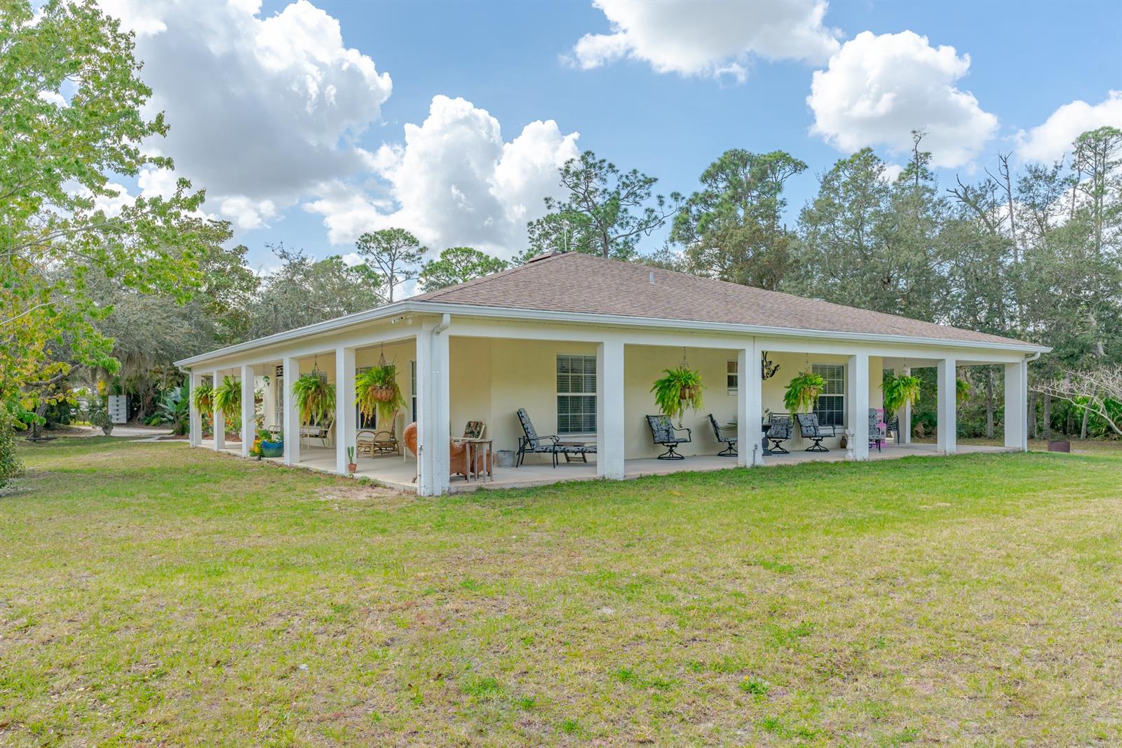 Don't miss out on this awesome New Smyrna Beach compound with privacy galore! This 3/2 block home has a gorgeous wrap around porch which surrounds 3 sides of the house. The 4th side is occupied by a huge 3+ car garage/workshop that would be any car, motorcycle or woodworker enthusiast dream! Built in 2003 and is surrounded by nature, complete with deer and birds galore. Outside you will find tons of room with a paver patio & firepit. Located just down the street from the wonderful Swoop Municipal Boat Ramp and intracoastal waterway and just a short drive to the amazing Canal St and Flagler Avenue shopping areas of artsy New Smyrna Beach. ;Water: City