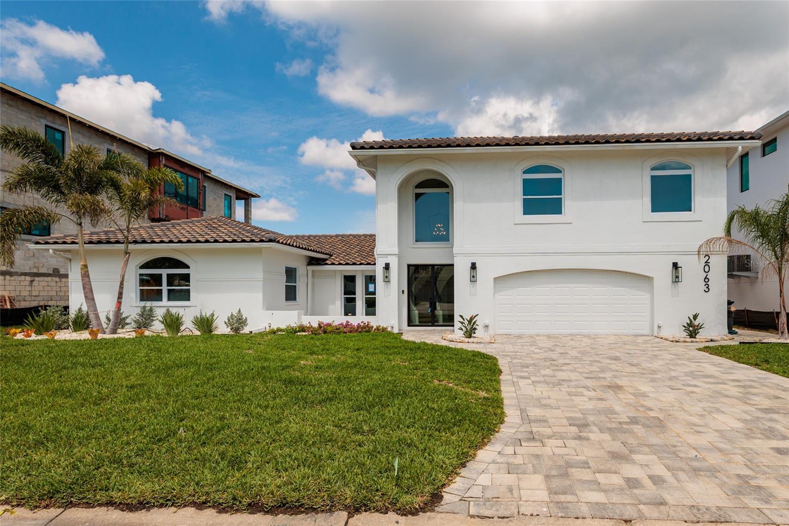 Welcome to an extraordinary waterfront estate in the prestigious community of Venetian Isles, offering luxury living just three homes from open water Tampa Bay. Perfectly positioned on an expansive 85’ x 120’ sailboat-water lot, this extensively renovated two-story residence delivers 4,344 heated square feet of refined coastal elegance with five bedrooms, three full baths, and one half bath designed for both grand entertaining and everyday comfort. A rare offering in one of Northeast St. Petersburg’s most sought-after waterfront neighborhoods, this home has undergone a comprehensive high-end transformation with virtually every major component updated. A new tile roof was installed in 2020, and in 2026 the home received extensive upgrades including all-new kitchen, bathrooms, flooring, plumbing, electrical systems, designer lighting, fixtures, hurricane-impact windows, ceiling fans, and fresh interior and exterior paint. Every detail has been thoughtfully curated to create a sophisticated modern aesthetic while maximizing comfort and functionality.
The chef-inspired kitchen is truly the centerpiece of the home, featuring top of the line appliances, a striking 48-inch gas cooktop, custom cabinetry, quartz countertops, and top-tier finishes designed for culinary enthusiasts and entertaining alike. Multiple living and gathering spaces throughout the home provide exceptional versatility, enhanced by two elegant gas fireplaces that add warmth and ambiance. The flexible bedroom layout is ideal for multi-generational living, guests, or remote work lifestyles. The luxurious upstairs primary suite serves as a private retreat, offering a spacious bedroom, spa-inspired bath, and an additional flex space perfect for a nursery, gym, office, or private sitting area. A large laundry room with custom cabinetry and quartz countertops adds both style and convenience.
Outdoor living is equally impressive, showcasing a large waterfront pool and spa, expansive covered patio, beautifully landscaped grounds, and a welcoming front courtyard that creates stunning curb appeal. The wide canal setting provides an exceptional boating lifestyle with quick access to Tampa Bay. The seawall has been professionally capped and reinforced with a belly band, offering enhanced durability and long-term peace of mind. This premier waterfront location places you less than 10 minutes from vibrant Downtown St. Petersburg, where you can enjoy award-winning restaurants, waterfront parks, museums, boutique shopping, and an exciting arts and entertainment scene. Convenient access to major roadways also allows for easy travel to Tampa, area airports, and the Gulf beaches. This move-in-ready Venetian Isles estate combines luxury, boating lifestyle, modern upgrades, and an unbeatable location into one remarkable property. Schedule your private showing today and experience elevated waterfront living at its finest.