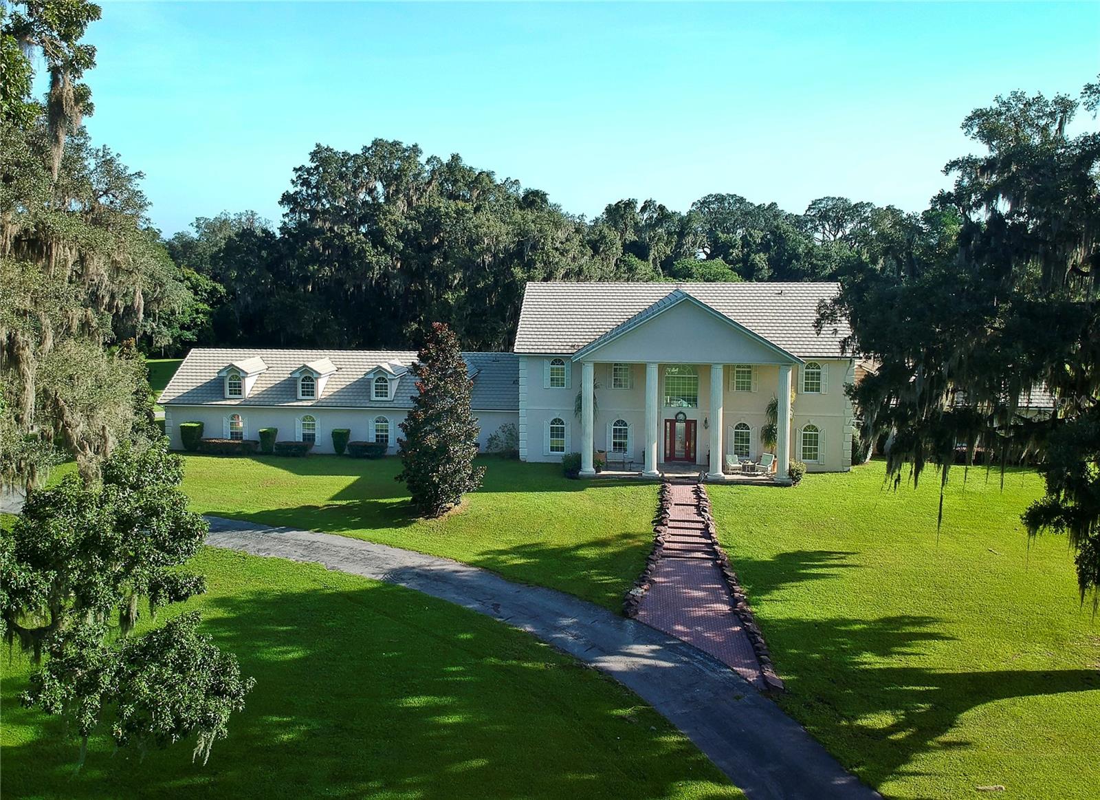 Looking for a spacious, one-owner estate home in NW, Ocala Florida? Can be divided House with 45 Acres or Barn and Arena with 45 Acres, call for more information. Then you need to check out this 90-acre Marion County estate. Located just off 225A, a stone’s throw from WEC, this property offers peace and quiet as well as one of the highest elevations in the county. The custom pool home has an impressive entrance on paved roads, lined with oak trees, where you’ll also find the custom 22-stall center-aisle block barn. The barn also has an office and tack and feed room. And that’s not all. You’ll also find a 250 x 136 arena and a nine-bay equipment barn. There are spacious board paddocks, too. All this, plus a magnificent custom pool home at the top of the hill with 4 bedrooms, primary suite on the lower level, amazing kitchen with all the upgrades and so much more!  Make your appointment today.  LIsting agent is related to the Sellers.