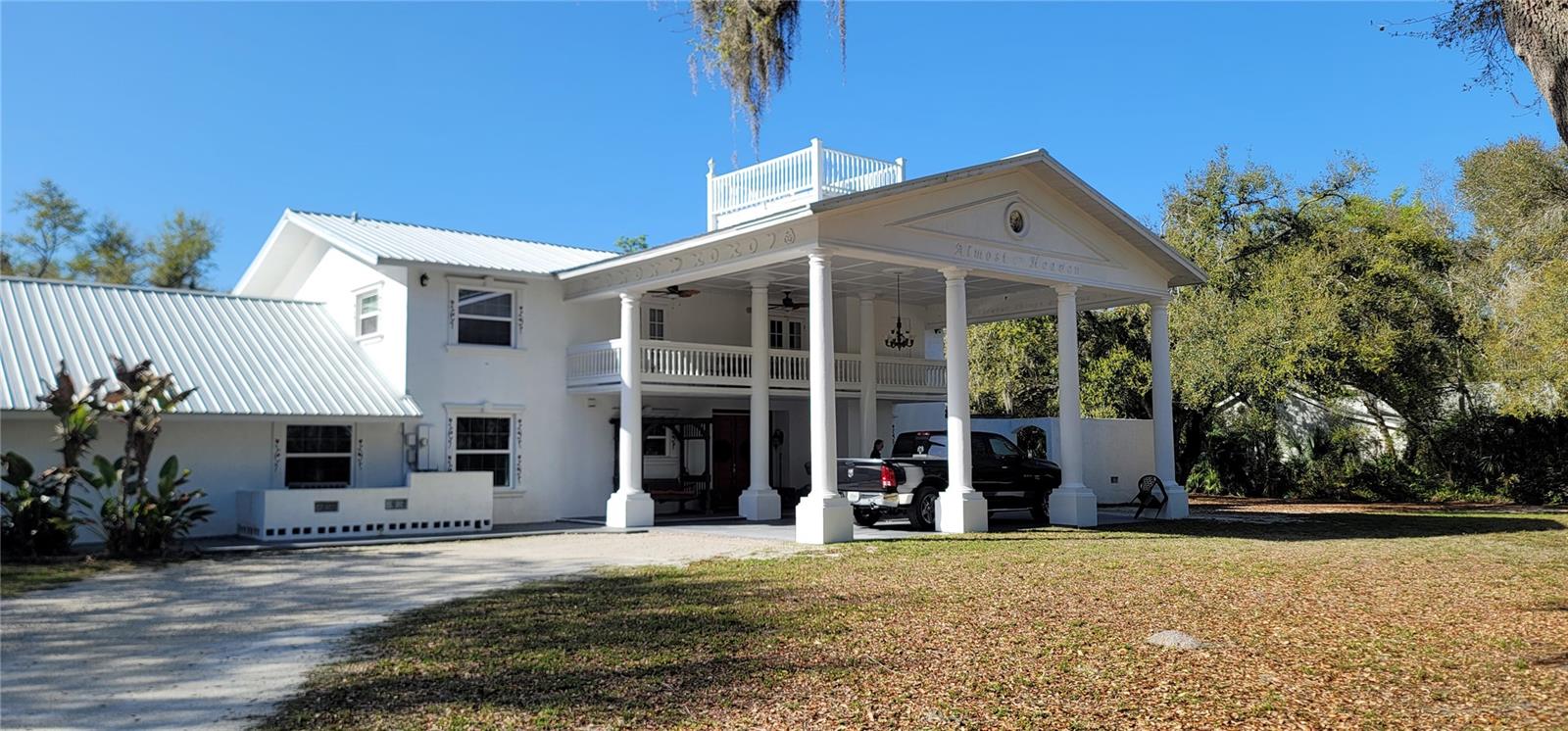 This 3.5 acre property offers more then meets the eye.  When you drive up to the main house you are greeted with a circular driveway that leaves you at the entrance of the home. This 2 story home has a private elevator to a guest suite on the second floor with full bath, walk in closets and full kitchen and living room and a screened in balcony.  The first floor has a living room, dining room, kitchen, main bedroom, 2 more bedrooms with full baths. The Garage was converted into a Billiard Room with separate office and entrance to the back yard. There is a second floor private entrance apartment with bedroom, kitchen and full bath.  The out buildings are plentiful and the 3 RV pads are equipped to rent out. Complete with inground pool, out building that serves as another apartment for rent if you choose. The home can be homesteaded or continue to be a great source of rental income.  Several large work shops and sheds are spread throughout the property. The largest can accommodate an RV and is 60x48x17! Gas fireplace, ceramic tile and laminate flooring. This is a once in a lifetime opportunity to own 3.5 acres so close to all shopping and more. Outside shower surrounded by Privacy wall 10x14, large Billiard Room with closets, study/craft room with built in cabinets and closets, open kitchen with tile countertops,  screened in balconies up and down. Cash offers only.
