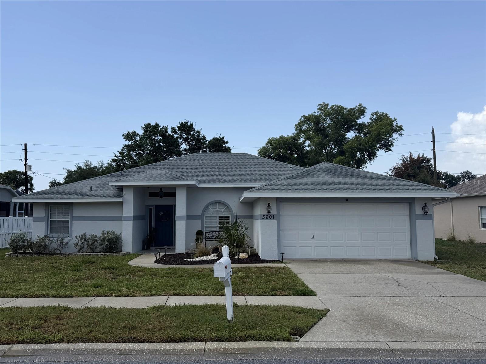 Welcome to this beautifully maintained 3-bedroom, 2-bathroom home located in the Glenwood of Gulf Trace community in Holiday. Offering 1,617 square feet of living space, this home features a spacious open floor plan with a desirable split-bedroom layout, providing both comfort and privacy. The inviting interior showcases updated laminate flooring installed in 2021, a bright and functional living space, and a well-appointed kitchen featuring stainless steel appliances and granite countertops. The spacious primary suite offers a private retreat with an updated en-suite bathroom completed in 2025, featuring quartz countertops and modern finishes. Enjoy Florida living year-round from the screened-in lanai overlooking the backyard, which offers plenty of room for a future pool and outdoor entertaining space. Located in a quiet, established neighborhood, this home provides the perfect setting for relaxing evenings or gatherings with family and friends. Additional highlights include a newer HVAC system installed in 2023 and a professionally completed grout repair in 2003, with all related reports available for buyer review. Conveniently located near numerous dining options, parks, the J. Ben Harrill Recreation Complex, shopping, and zoned schools, this home offers the perfect combination of comfort, updates, and location. Don't miss the opportunity to make this Glenwood of Gulf Trace home your own!