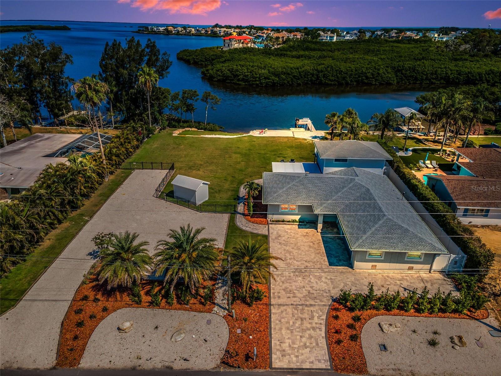 SALT LIFE AT THIS EXQUISITE SEABREEZE ISEL ESTATE!! YOUR NOT SEEING DOUBLE, THIS IS A DOUBLE LOT THAT HAS A BEACH ON IT, DOCK, JET SKI RAMPS ETC...NOT ONLY THAT; PARKING FOR ALL YOUR TOYS! NO HOA, Stunning Remodeled Waterfront Retreat on the Gulf! Discover this beautifully remodeled 1957 quality built coastal gem, that sits on over a 1/2 acre, expanded and upgraded to have the ultimate waterfront lifestyle. Nestled on an oversized lot with 140 feet of prime Gulf frontage, this home blends timeless charm with modern luxury. Enjoy panoramic views of the barrier islands and Anclote lighthouse from your private sandy beach — a rare and serene feature. Put those toes in that sand!! The brand-new seawall ensures lasting protection while enhancing the property's pristine shoreline. With an observation dock & floating jet ski ramps. This homes kitchen can satisfy any chefs demands!! I went over board on those pictures, but its awesome! It also has three spacious bedrooms. The Primary Bed room has an outside deck that overlooks this magnificent lot and breathtaking views. The Primary Bath has duel sinks with in wall faucets, pretty unique! The choice of tile & inserts are just perfectly done! in addition to the 3 bedrooms this home also has a dedicated office, ideal for working remotely or creating a cozy den. Each and every bathroom is tastefully done. The open-concept living area flows seamlessly to the water-facing deck, perfect for soaking in sunsets or entertaining guests. The huge screened-in lanai is great for entertaining on those stormy nights. Pavers line the back yard plus provide outdoor conversation areas to watch those amazing sunsets!! The driveway has beautiful pavers as well that enhances this beautiful homes entrance as does the off road extended pebble driveway that offers space for RV, boat, or jet ski parking. Extra outdoor shed that you might need for your extra items or also can be a pool house if you desire to add your dream pool. This home also provides an oversized 2 car garage with Golf Cart area or motorcycle. It has also outside garage access door and 2 Hurricane rated in & out garage doors. Almost forgot to mention the the tasteful fencing around entire property. With expansion onto an extra lot. the property provides unmatched space and flexibility for coastal living. Don't miss this rare opportunity to own a piece of Gulf-front paradise, where every day feels like a vacation.