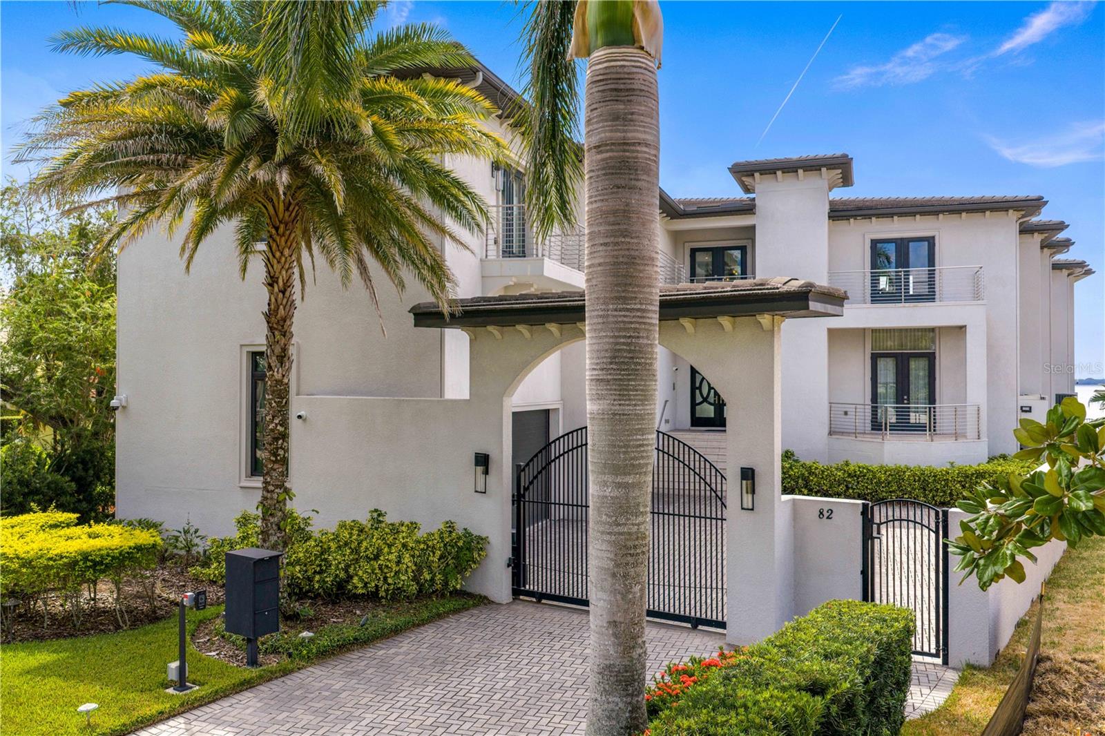 Experience the ultimate in waterfront living with this extraordinary Davis Island home, perfectly positioned on the open bay.  Designed for both grand entertaining and resort-style relaxation, this five-bedroom, eight full and two half-bath masterpiece offers 9,646 square feet of indoor living space and over 12,500 square feet including terraces and garage- a true showcase of modern Tampa Bay luxury.
A gym and a home office, both with closets and bathrooms offer flexible living options to suit your lifestyle. From the moment you arrive, the home’s modern architecture and sweeping bay views set the stage for an exceptional lifestyle. The rear exterior is an entertainer’s dream, featuring a uniquely designed layout that allows for both large gatherings and intimate moments - enjoy a central seating group within the pool, a fireplace, a round fire pit, and a fully equipped outdoor kitchen, all connected by multiple terraces and balconies. A whole-home sound system extends throughout the interior and outdoor living areas, with multiple zones for the pool deck, balconies, and outdoor kitchen - all complemented by TV seating areas for al fresco entertaining. Indoors, you’ll find sophisticated modern finishes including a stunning spiral staircase, designer lighting, and expansive windows that capture breathtaking water views. The open-concept chef’s kitchen features high-end appliances, sleek cabinetry, a wall-sized wine display, and a large island—flowing seamlessly into the dramatic two-story living and dining area, perfect for gatherings of any size. The home’s entertainment suite offers endless enjoyment, complete with a full bar, game area with video wall, and home theater with projection system and dedicated sound. This thoughtfully designed space connects through a bar seating area, ideal for mingling or movie nights. For wellness, a dedicated gym and a serene yoga/meditation room provide inspiring spaces overlooking Tampa Bay. Car enthusiasts will appreciate the four-car garage with 16-foot ceilings, designed to accommodate lifts and prized collections up to eight cars. Enjoy comfort and safety with a cutting-edge security system designed to protect your home and loved ones with remote monitoring; and a whole house generator for complete peace of mind. With multiple terraces on every level, an expansive pool and spa, this home offers varying features that define outdoor living in Tampa’s year-round beautiful weather. Your private dock ,with boat lift, offers effortless access to open bay waters. Living on Davis Island means joining one of Tampa’s most exclusive and vibrant communities—just minutes from downtown, Water Street, Amalie Arena, and Tampa International Airport. The island offers local restaurants, boutiques, parks, marinas, dog parks, tennis club, private airport, and golf cart-friendly streets. Beaches, Riverwalk attractions, and even Disney are all within easy reach. Discover the perfect blend of luxury, comfort, and location — welcome home to Davis Island’s premier waterfront estate.