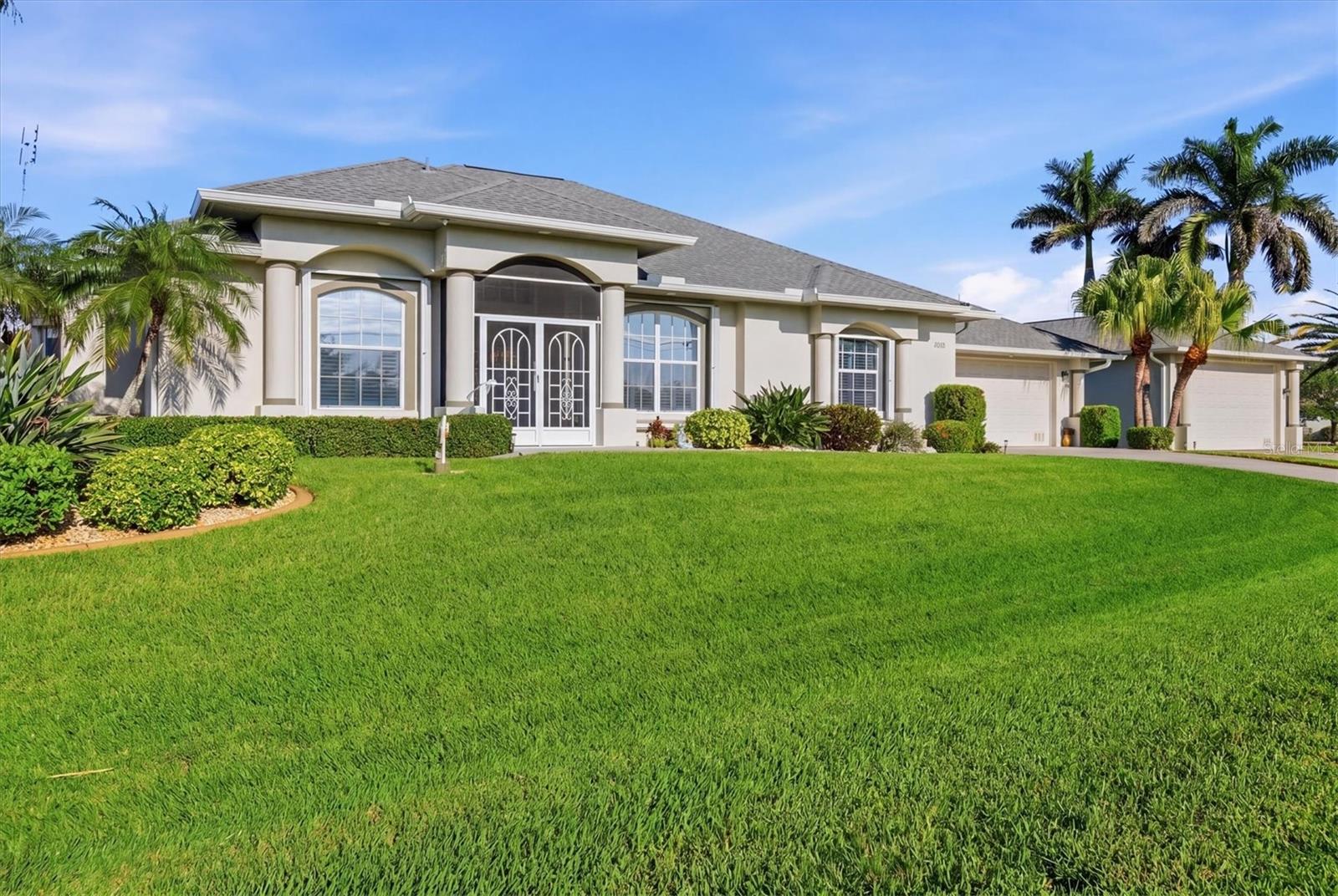 WOW, this home has it all! Exceptional waterfront living in the highly sought-after waterfront community of South Gulf Cove on 2 lots with 182 feet of seawall, plus an additional 153x85x140 ft. lot across the street with its own fire pit area. This beautifully maintained property offers 3 bedrooms, 2 bathrooms, plus a pool bath, along with an impressive blend of indoor comfort, outdoor living, boating amenities, and incredible garage and storage space.
From the moment you arrive, you’ll notice the screened front entry, electric roll-down front door closure, and lush mature landscaping surrounding this meticulously manicured property. Inside, the home showcases beautiful architectural details throughout, including chair rail in the dining area, a tray ceiling in the primary bedroom, and under-vanity lighting in the primary bath. The kitchen features granite countertops, a custom bar to match, and a custom-built pantry.
This home is loaded with upgrades, including 3-zone HVAC controls, ADT alarm on both the house and detached garage, 8 security cameras with recorder and TV, Manabloc plumbing, water softener, and a 5-stage reverse osmosis system plumbed to the refrigerator and laundry tub. Additional features include pull-down attic storage with plywood flooring, 8-zone irrigation, two drilled wells for lawn watering, upgraded St. Augustine grass, Regency ceiling fans, and accordion storm shutters with additional acrylic panels for select windows.
The outdoor space is just as impressive. Enjoy the pool with a new saltwater chlorinator system and pool heater replaced in 2024, added pool closet storage with shelving is a bonus, 2 outdoor Bose speakers, and 6 interior speakers powered by a Yamaha sound system. A paver walkway leads to the 7x30 cement dock, with additional paver access along the right side of the home from front to back. Boaters will love the 10,000 lb boat lift, 29' canopy cover, and 24' aluminum walk plank.
Car lovers, hobbyists, and anyone needing serious storage will appreciate the attached double garage, plus a single garage ideal for a craft room, workshop, hobby space, fitness area, or flex space. The standout feature is the detached 24x48 garage with an 18x10 overhead door, wired for a generator and perfect for a car collection, boat storage, RV or trailer storage, workshop, business equipment, or recreational gear.
Located in one of Charlotte County’s most desirable waterfront communities, South Gulf Cove is a boater’s dream with 55 miles of canals, a short ride to the Zephyr Waterway and one bridge to open water. Convenient to boating, fishing, Gulf beaches, golf courses, dining, and more, this property offers the ultimate Florida lifestyle. Pride of ownership shines throughout, and with most furnishings and features already in place, this home is nearly turnkey with only a few excluded items. Opportunities like this are rare. With exceptional waterfront access, extensive garage space, premium upgrades, and beautifully maintained grounds, this is truly one of South Gulf Cove’s standout properties.