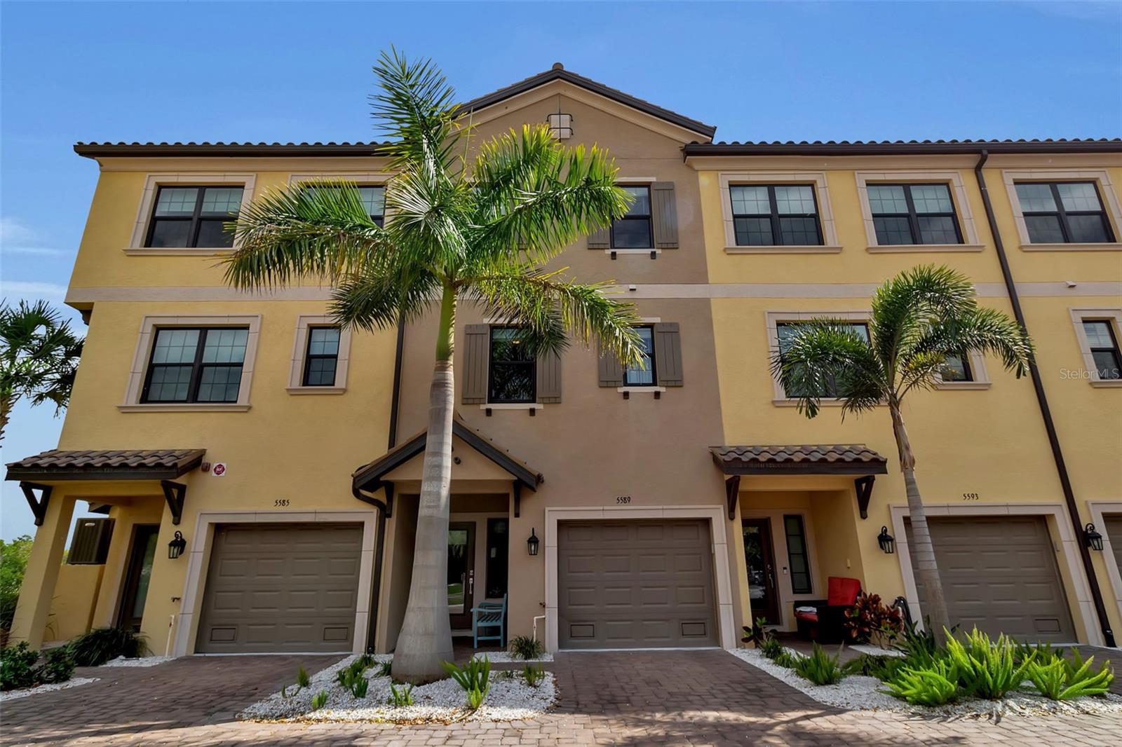 Welcome to 5589 Cannes Circle—an exceptional waterfront townhome in the gated community of Phillippi Landings, where refined design meets effortless Florida living. Perfectly positioned along Phillippi Creek, this residence offers breathtaking water views and a rare sense of privacy, all just minutes from The Landings Shopping Center, Siesta Key, and downtown Sarasota.

This impeccably maintained three-story home features 4 bedrooms, 3 full baths, and a bright, open-concept layout designed for both everyday comfort and entertaining. Soaring ceilings, abundant natural light, and thoughtfully selected finishes create a clean, contemporary aesthetic throughout. The designer kitchen is equipped with solid surface countertops, stainless steel appliances, 42” cabinetry and perfectly appointed island that flows seamlessly into the main living space.

Multiple outdoor living areas—including two private lanais—invite you to enjoy the peaceful creek views and lush tropical surroundings. A private elevator provides access to all levels, while the oversized garage offers generous storage for boats, kayaks, beach gear and more.

Built with quality and efficiency in mind, the home includes impact-rated windows, energy-efficient systems, LED lighting, and durable finishes such as beautifully maintained engineered wood flooring throughout. Additional upgrades include Moen fixtures, Kohler plumbing features, and professionally designed landscaping within the community.

Offered in immaculate, move-in ready condition, this residence is available to purchase furnished for a turnkey experience or unfurnished to suit your personal style—making it an ideal full-time home, seasonal retreat, or turnkey investment opportunity. Furnishings offered separately.

Residents of Phillippi Landings enjoy a resort-style lifestyle with amenities including a heated pool, fitness center, dog park, clubhouse, kayak launch, and a scenic boardwalk along the water. The adjacent Phillippi Harbor Club marina offers convenient access for boating enthusiasts.

This is a rare opportunity to own a waterfront-facing home in one of Sarasota’s most desirable communities. Call today for a private showing!