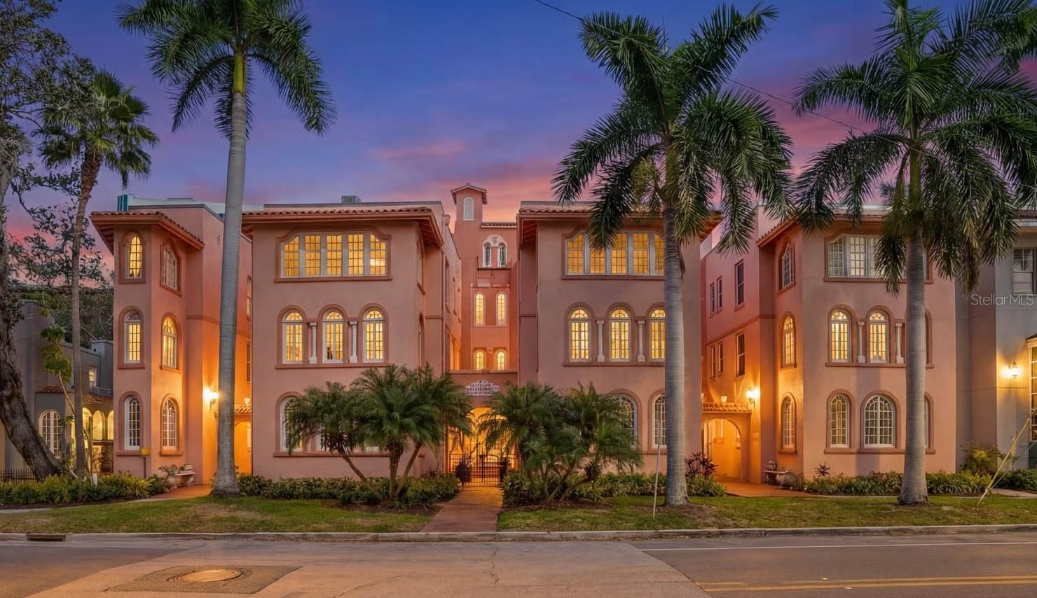 One or more photo(s) has been virtually staged. Tucked inside the historic 1924 Frances Carlton on Palm Avenue, this fully reimagined residence offers something rarely found in downtown Sarasota, the character of a vintage building paired with the comfort of a completely rebuilt interior.

Created by combining two residences, the home spans almost 1,600 square feet and lives more like a private apartment than a typical condominium. High ceilings, original arched windows, and defined rooms preserve the architectural charm, while a comprehensive renovation brings the home entirely into the present.

You enter directly into a generous, open kitchen, an unexpected feature in a building of this era, designed for daily living and gathering rather than passing through. Custom cabinetry, stone surfaces, Café appliances, and thoughtful lighting create a space that is both refined and welcoming. Plantation shutters throughout soften the natural light while maintaining privacy.

The living areas flow naturally toward the sunroom overlooking Palm Avenue, where warm southwest afternoon light fills the space. At the opposite end of the home, the primary suite offers a different experience entirely. Positioned at the rear of the residence, it extends into a second enclosed sunroom overlooking a small garden courtyard. Accessible through the bedroom, this space becomes a quiet retreat, ideal for morning coffee, reading, or a peaceful workspace.

The renovation extends well beyond cosmetics. Flooring, kitchen, baths, electrical, plumbing, lighting, and finishes have all been rebuilt, complemented by two new air-conditioning systems and a tankless water heater. The result preserves the building’s architectural soul while providing the reliability of a much newer home.

The residence includes in-unit laundry, two assigned secured parking spaces, and access to the community pool within an intimate building of twenty residences.

From here, downtown Sarasota is part of everyday life. Florida Studio Theatre, Sarasota Opera, restaurants, cafés, and evening drinks are just one or two blocks away, with the Bayfront and marina a short walk beyond.

For those seeking amenities and high-rise living, downtown offers many options.
For those seeking charm, history, walkability, and a home that feels genuinely unique, opportunities like this are very rare.