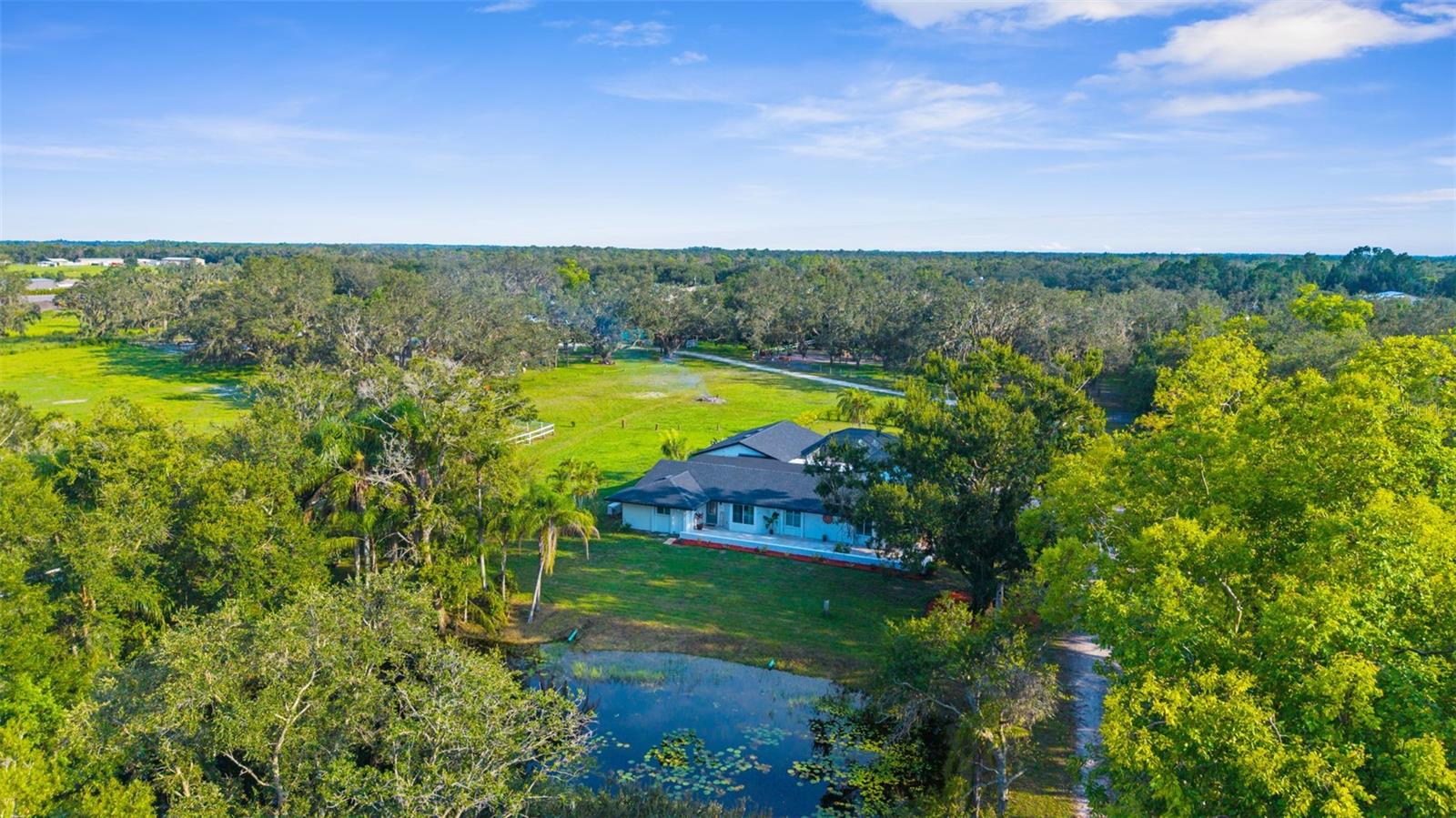 Impeccable 10-Acre "High-and-Dry" Estate: A Masterpiece of Luxury & Resilience ~ Step into a lifestyle of absolute comfort and sophistication. This meticulously maintained 10-acre estate on the E State Road 64 corridor is a rare gem, offering the perfect blend of high-end design and rural tranquility. From the moment you enter, the home’s open floor plan and soaring ceilings create an atmosphere of light-filled elegance, perfect for both intimate family gatherings and grand-scale entertaining.  Exquisite Interior & Exterior Craftsmanship ~
Gourmet Designer Kitchen: A true chef's delight, featuring state-of-the-art appliances, sleek modern finishes, and artisan craftsmanship following 2026 luxury design trends. Luxurious Living Spaces ~ Every room tells a story, with custom woodwork, high-end fixtures, and nature-mimicking textures providing a sense of sculptural sophistication.  Outdoor Haven: Your private backyard is an oasis, featuring professional landscaping, expansive patio areas, and intimate gathering spots designed for a "boutique resort" feel. 
Turn-Key Horse Infrastructure ~ Designed for the serious equestrian, this property includes a fully-equipped barn with oversized stalls, a dedicated tack room, and a professional layout for efficient daily operations. Premium Pastures & Arenas ~ The 10-acre parcel features fully cross-fenced acreage with lush pastures and a premier riding arena tailored for training and recreation. Immediate Revenue Opportunity ~ The established infrastructure is ideal for private use, professional training, or a high-demand boarding operation, offering immediate income potential in a desirable market.  The Strategic Advantage ~ Resilience & Growth ~ Totally "High and Dry": Peace of mind is built-in. This property boasts high elevation and remained completely dry during historic 2024 storms, a critical differentiator in today’s Florida market.  SR 64 Corridor Expansion (FDOT FPID 454649.  Position yourself for future appreciation. The property is at the center of the FDOT plan to transform SR 64 into a modern 4-lane highway, improving safety and regional connectivity. Future Utility Readiness: The ongoing state project includes planning for central water and wastewater extensions, a development that traditionally serves as a major catalyst for property value growth. A Move-In Ready Legacy Property ~ This isn't just a home; it’s a strategic asset. Whether you are seeking a premier equestrian retreat, a private family legacy, or a high-value land bank, this estate is ready for its next chapter. Take advantage of this unique opportunity to own a high-elevation, luxury parcel prior to regional infrastructure further accelerates market demand.- The beautifully renovated main residence spans over 3,100 square feet and includes 4 bedrooms and 3 bathrooms. Designed with both comfort and entertaining in mind, the home offers spacious open-concept living areas, a completely updated kitchen, walk-in closets in every bedroom, and contemporary finishes throughout. Outdoor living is equally inviting, with a screened lanai and heated pool overlooking serene acreage. An attached 3+ car garage includes a built-in safe room, Additional structures enhance the property’s functionality, including a renovated 1-bedroom, 1-bath caretaker’s bunkhouse with a full kitchen and living area. It also connects to a 39’ x 23’ workshop featuring 12-foot ceilings and a 16-foot door—perfect for equipment storage or business use.