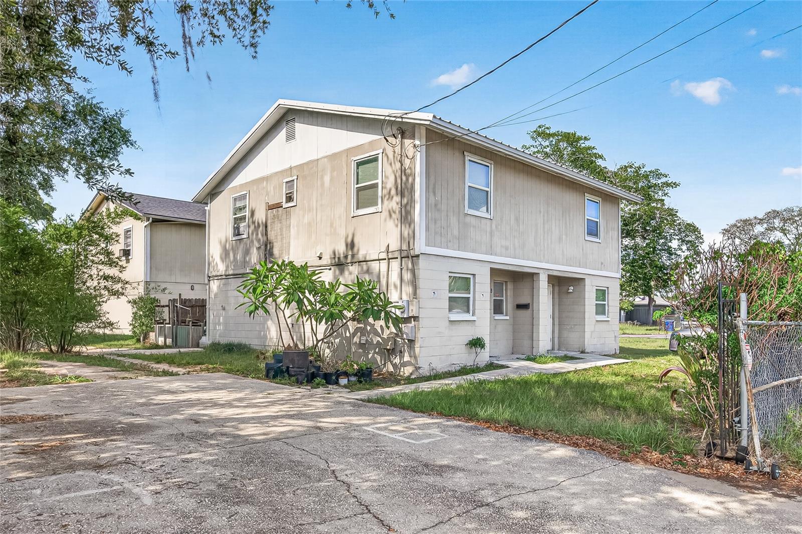 This duplex offers approximately 2,000 heated square feet and features two 2-bedroom, 1.5-bath units. Built in 1985, the property includes central air conditioning, tile, carpet, and concrete flooring, public water and sewer services, assigned parking, and a metal roof. The property provides convenient access to major roadways, shopping, dining, parks, schools, and other local amenities.
