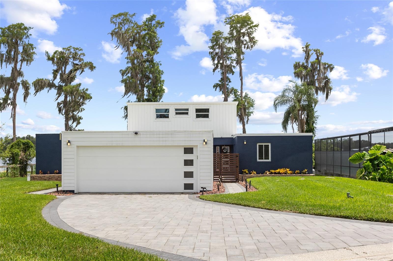 An incredible value for a large, feature-packed pool home directly on private ski lake Lake Stemper, complete with a covered dock and detached ADU! Set on a quiet cul-de-sac along the shores of Lake Stemper, this updated lakefront pool home delivers the Florida lifestyle buyers are searching for—boating, swimming, entertaining, and sunset views from home. Lake Stemper is a private ski lake shared by only approximately 20 homes, offering exceptional privacy with direct access to year-round water recreation. The home is not in a flood zone so flood insurance is not required, and lives in unincorporated Hillsborough county!

The home is designed around a private courtyard with a heated saltwater pool, creating a secluded outdoor retreat at the center of the property. The pool and surrounding pavers were installed and sealed in April 2022 and resealed in April 2024. Inside, soaring ceilings, expansive windows, custom shades, contemporary finishes, and a ProFlame electric fireplace give the open living spaces a bright, modern feel. The renovated kitchen features sleek cabinetry, stainless steel appliances, and an expansive island, while multiple rooms showcase impressive lake views.

The outdoor living spaces are built for entertaining. A fully equipped outdoor kitchen added in 2022 includes a Blaze four-burner propane grill, flat top and side burner, sink, ice maker, granite countertops, and under-counter LED lighting. Beyond the spacious lakeside deck, a private covered dock completed in 2022 puts boating, skiing, and sunset cruises just steps from the back door. A detached ADU with a private entrance and kitchenette adds valuable flexibility for guests, multigenerational living, a home office, or a studio. Major improvements include a water heater installed in 2020, pool and paver courtyard completed in 2022, outdoor kitchen added in 2022, covered dock completed in 2022, professional exterior lighting in 2024, and a new septic tank and drain field completed in 2025.  With no HOA and no CDD, this is a rare opportunity to enjoy updated, private lakefront living without giving up everyday convenience.