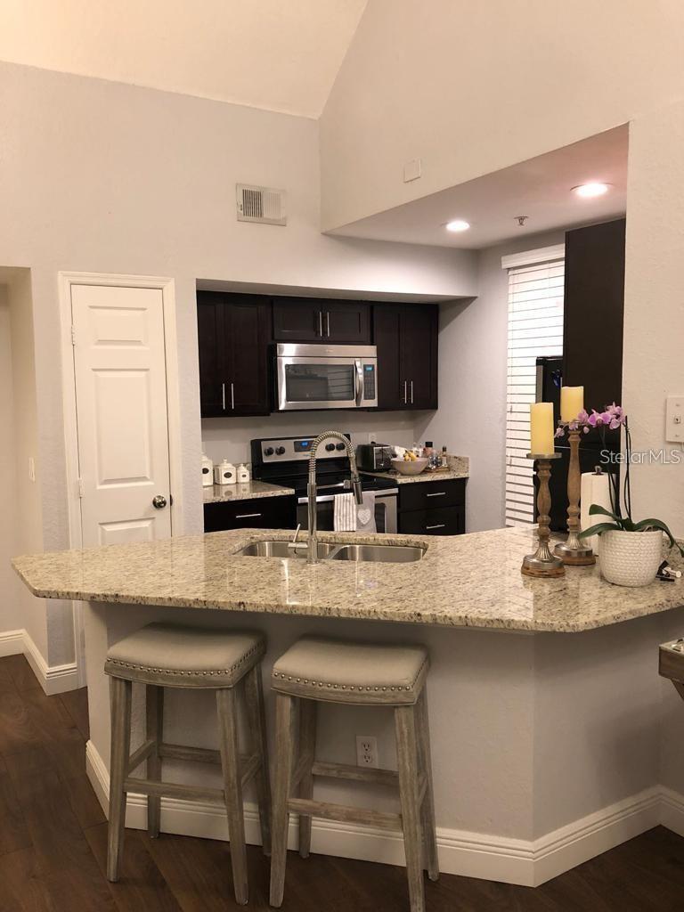 This is a beautiful end unit, ground floor access to a spacious apartment on the second floor it has a loft, makes a great office or study or additional bedroom. Apartments has stainless steel appliances, granite countertops and renovated bathrooms. Great location, next to super market, near Universal theme parks, Millennia Mall and Downtown with easy access to I-4. Gated community, amenities include gym, pool access. HOA Approval required.