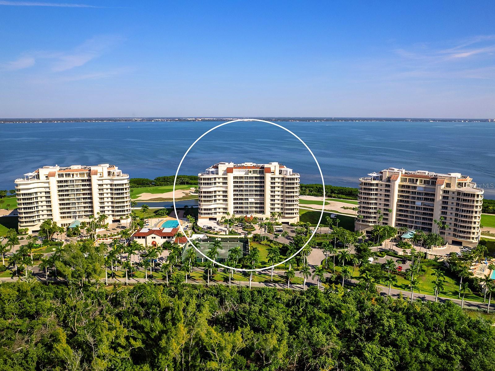 Beautifully positioned within Grand Bay on Longboat Key, this 2-bedroom + den residence offers 2,550 sq ft of light-filled living with a private elevator opening directly into the home. Expansive Sarasota Bay views, two generous terraces, and seamless indoor–outdoor flow create an ideal setting for sunsets, bay breezes, and relaxed coastal living. Set behind the gated Bay Isles entrance, residents enjoy resort-style amenities, deeded beach access, and a lifestyle defined by location, comfort, and waterfront elegance.

The spacious primary suite offers a tranquil retreat with direct terrace access, peaceful water views, a large walk-in closet, and a spa-like bath featuring dual vanities, a soaking tub, and a walk-in shower.

The generous kitchen featuring a Sub-Zero refrigerator and causal eat-in dining, den, and guest suite each open to a second terrace that overlooks Bay Isles’ beautifully landscaped grounds and tennis courts. The den offers versatility for a home office or additional living space, while the guest suite features an en-suite bath and private access to the expansive terrace. A dedicated wine and storage room adds a thoughtful layer of convenience and elegance, blending seamlessly into the home’s well-planned layout.

Grand Bay residents enjoy an array of resort-style amenities, including two pools, a fitness center, tennis courts, a clubhouse, and deeded beach access through the Bay Isles Beach Club. Set behind the secure gates of Bay Isles, this residence offers the perfect blend of space, privacy, and the coveted Longboat Key lifestyle.