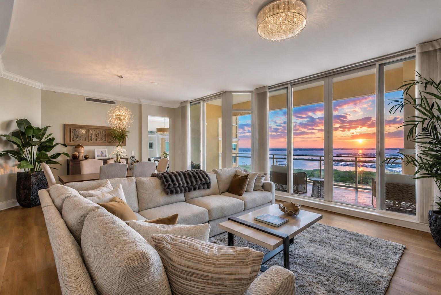 Welcome to LUXURY WATERVIEW LIVING on the 12th floor in the desirable RAPALLO FLOORPLAN at BEL MARE, where an impressive 3,350 TOTAL SQUARE FEET of thoughtfully designed space is paired with SWEEPING WATER VIEWS. From this elevated residence, take in panoramic scenes of the MANATEE RIVER, ANNA MARIA ISLAND, the iconic SUNSHINE SKYWAY BRIDGE, and out toward the GULF, all setting the stage for unforgettable SUNSET VIEWS. This spacious home offers a SPLIT FLOOR PLAN with three bedrooms, each featuring ENSUITE BATHS, along with a DEN/OFFICE and POWDER ROOM, creating flexibility for guests or remote work. Expansive FLOOR-TO-CEILING IMPACT WINDOWS fill the interior with natural light and showcase HIGH CEILINGS and open-concept living and dining areas that flow seamlessly onto a PRIVATE BALCONY—perfect for enjoying the coastal breeze. The kitchen is both inviting and functional, complemented by UPDATED LIGHTING that adds a fresh, modern touch throughout the home, and the recent installation of TWO BRAND NEW AC UNITS WITH A 2-YEAR TRANSFERABLE MAINTENANCE AGREEMENT provides added comfort and peace of mind. The PRIMARY SUITE offers a peaceful escape with water views, DUAL WALK-IN CLOSETS, and a SPA-LIKE BATH featuring a soaking tub and walk-in shower. Residents of this GATED WATERFRONT COMMUNITY enjoy access to RESORT-STYLE AMENITIES including multiple pools, a fitness center, pickleball courts, a theater, social gathering spaces, guest suites, and scenic walking paths, along with access to the RIVIERA DUNES BEACH CLUB. COVERED PARKING and CLIMATE-CONTROLLED STORAGE provide added convenience, while the adjacent MARINA and WATERFRONT DINING at the Dockside restaurant with live entertainment enhance the lifestyle. Ideally located ACROSS FROM THE MARRIOTT AND ITS POPULAR AMPHITHEATER “THE YARD”, featuring live music, comedy acts, and vibrant markets, this residence places you in the heart of an active and growing waterfront destination. Just minutes to DOWNTOWN BRADENTON, SARASOTA, TAMPA, and the GULF BEACHES, the location offers both energy and ease. Added confidence comes with the building’s full compliance with Florida’s STRUCTURAL INTEGRITY RESERVE STUDY (SIRS) requirements—where every day feels like a vacation and every evening ends with a view worth coming home to.