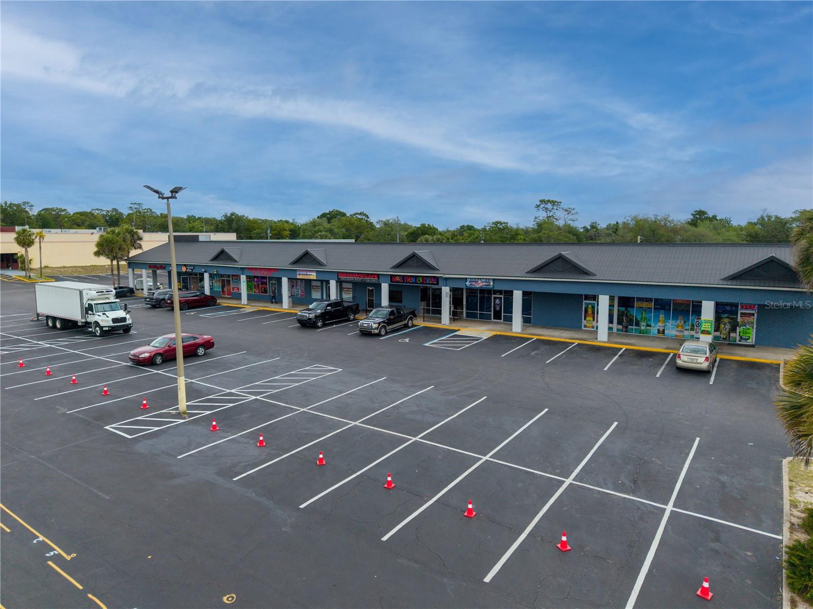 Here is your opportunity to acquire a 9-unit neighborhood shopping center located along the highly trafficked corridor. Offered at a price well below replacement price cost and highly competitive for the Ocala market, this property allows investors to secure a retail center at an attractive basis with built-in value-add potential. The property is strategically positioned in a dense and growing residential area, providing consistent tenant demand and strong visibility. All existing tenants are currently below market rents, presenting a clear path to increased revenue through lease renewals and repositioning.