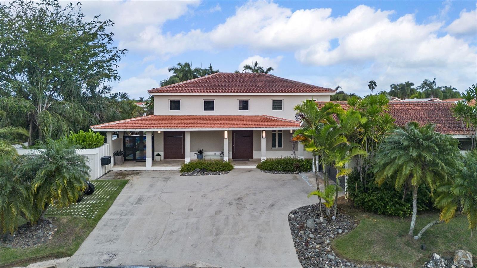 Located on Camino La Pomarrosa in Sabanera, Dorado, this enlarged Casona Carbia model sits on a corner lot within a quiet cul-de-sac, offering privacy and a thoughtfully designed living experience. The residence features 5 bedrooms and an open layout that supports both comfortable daily living and entertaining.

Interior spaces include a kitchen, living room, walk-in wine cava, and a dedicated pool table area. Additional areas provide flexibility for wellness and recreation, including a gym, golf simulator, and mini golf area.

Outdoor living is enhanced by covered terraces with BBQ, a pool, and a cold plunge, creating inviting spaces for relaxation and gatherings. The property is equipped with a generator, water heater, and dedicated golf cart space, and the sale includes a golf cart.

Situated within the established community of Sabanera Dorado, this corner residence offers a balanced blend of space, functionality, and lifestyle amenities.
