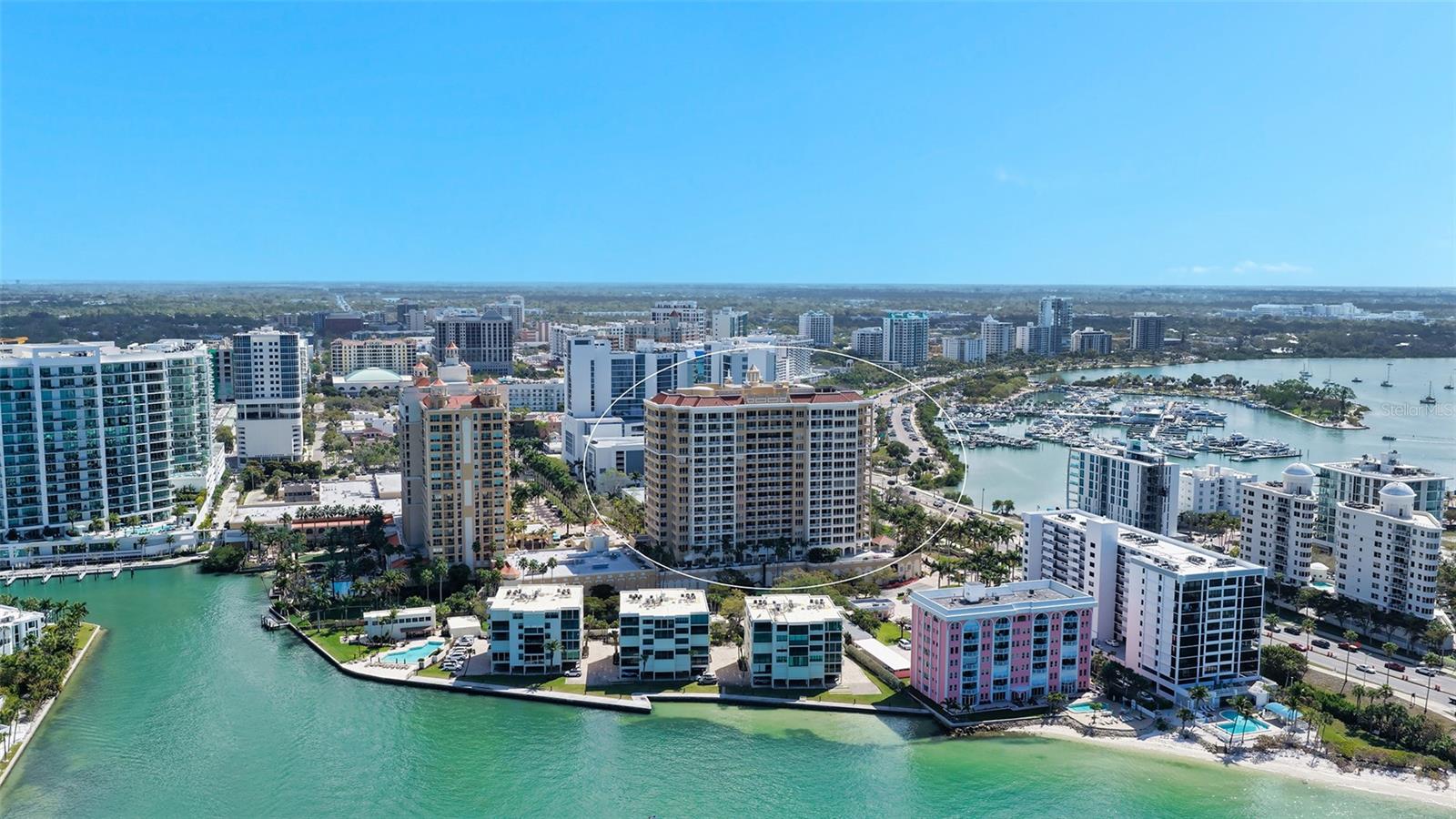 Perfectly placed on the 15th floor of the Ritz-Carlton managed Tower Residences, this corner residence captures sweeping panoramas of Sarasota Bay, the Bayfront yacht basin, the downtown skyline, and vibrant city lights stretching toward the horizon. Spanning nearly 2,800 square feet, the open floor plan is designed to frame water and city views from nearly every room while offering comfortable spaces for both everyday living and entertaining.
Travertine flooring flows throughout the main living areas, creating a cohesive foundation for the light-filled interior. The great room is surrounded by walls of floor-to-ceiling windows and glass sliders that open to the residence’s largest terrace, creating a seamless indoor-outdoor connection and an ideal setting for taking in Sarasota’s skyline and waterfront activity. Just beyond, the dining area is positioned to capture sweeping views while remaining conveniently connected to the kitchen.
The chef’s kitchen blends functionality with timeless design, featuring natural wood cabinetry, granite countertops, stainless steel appliances, and a breakfast bar that opens to the living areas. This thoughtful layout encourages effortless entertaining while maintaining clear sightlines to the water and city skyline.
All bedrooms feature bamboo hardwood flooring, offering warmth and contrast to the stone flooring in the main living spaces. The primary suite is privately positioned and serves as a relaxing retreat, complete with direct terrace access, dual walk-in closets, and a spacious marble en-suite bath with split vanities, soaking tub, and separate shower. The guest suite includes its own walk-in closet and a private terrace, while the third bedroom—currently arranged as a den or office—provides flexibility for guests or remote work.
The residence includes two secure under-building parking spaces and an air-conditioned owner’s storage unit located on the third floor.
Life at The Tower Residences offers the full benefit of Ritz-Carlton services and amenities. Residents enjoy concierge assistance, valet parking, and 24-hour room service from the adjacent Ritz-Carlton Hotel. Community features include a resort-style pool and spa (currently being updated), outdoor grilling and dining areas, an expansive social room with catering kitchen and fireplace, a theater, billiards and recreation room, elegant library and boardroom, and a fully equipped fitness center with locker rooms, sauna, steam room, and massage facilities.
Located in the heart of downtown Sarasota, this residence places the city’s waterfront lifestyle just outside your door. Marina facilities are less than half a mile away, while nearby Bayfront Park, the Sarasota Opera House, Van Wezel Performing Arts Hall, and numerous galleries and theaters anchor the city’s vibrant cultural scene. St. Armands Circle’s boutiques and restaurants are less than two miles away, and the white sands of Lido Key and Longboat Key’s Gulf beaches are only minutes from the property—bringing the very best of Sarasota living within effortless reach.
