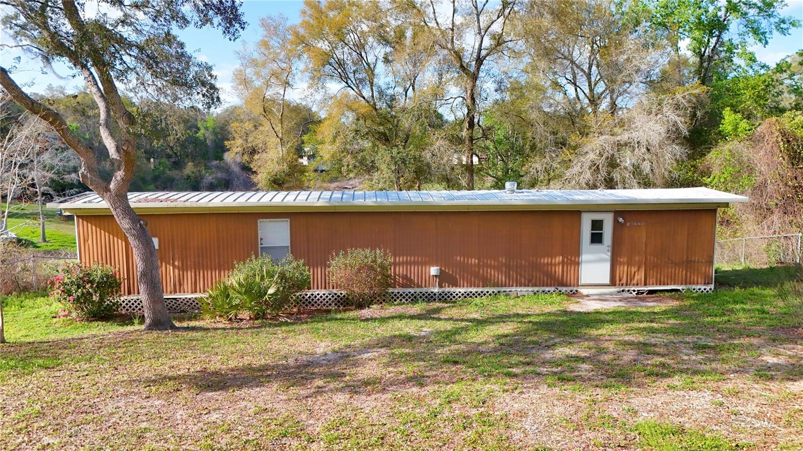 **Investor Opportunity with Lake Views & Total Privacy!** This 2-bedroom home in the Halfmoon Mini-Farms community offers a rare combination of security and scenery, featuring a **fully gated**  and a **picturesque lake view** right from your backyard. Perfectly positioned just a short drive from the heart of **Ocala**, this property is an ideal income-producing investment, whether you’re looking for a steady rental or a high-equity flip. Situated on over half an acre (**0.51 AC**), the land is high and dry in **Flood Zone X**, meaning no flood insurance is required. With **low annual taxes** ($1,006 in 2025), no HOA fees, and close proximity to Silver Springs State Park and the World Equestrian Center, this property offers incredible upside with minimal overhead. Priced at $95,000, this is a prime chance to secure a water-view asset in a rapidly growing market. **Cash offers only.**
