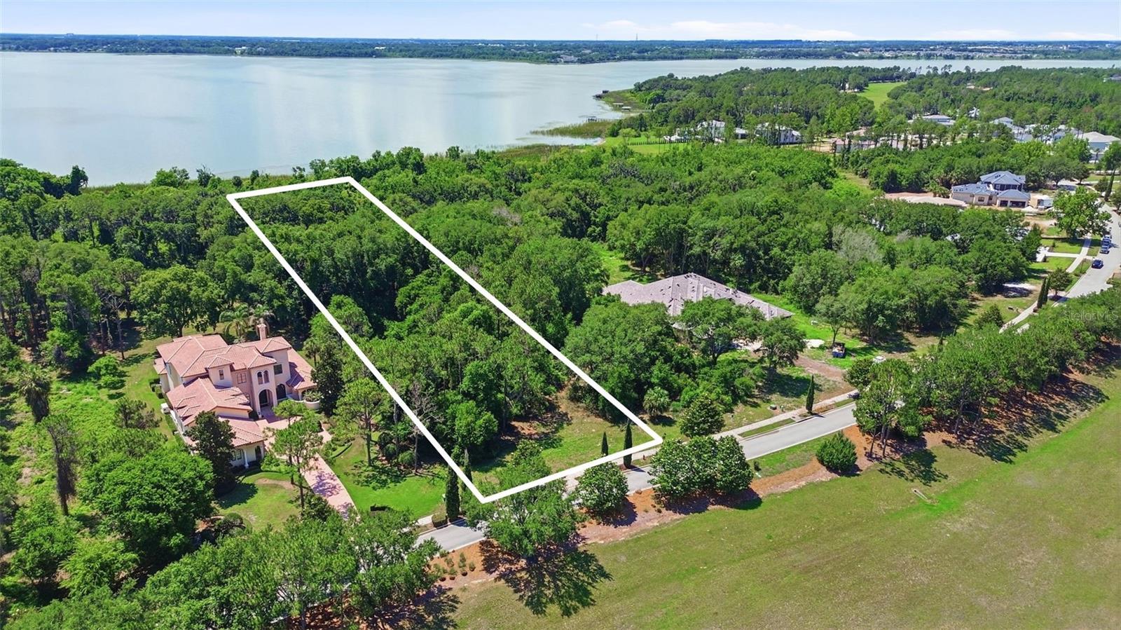 Build your forever home on the tranquil shores of Lake Apopka, inside one of Central Florida's most acclaimed luxury gated communities. This rare 1.26-acre homesite on Etruscan Lane offers 106 feet of lake frontage and an exceptional 541 feet of depth, a private, wooded canvas framed by mature trees and expansive water views. Bella Collina is a lifestyle defined by world-class refinement: an 18-hole Sir Nick Faldo–designed Championship golf course, Har-Tru tennis courts, pickleball, a resort-style pool complex, full-service spa, state-of-the-art fitness center, and multiple signature dining venues, all within the 24-hour guarded gates. Enjoy private, maintained roads, beautifully landscaped grounds, a dog park, and the quiet confidence of a community built around excellence. All utilities available: public water, sewer, natural gas, electric, and high-speed internet. Just 25 minutes from downtown Orlando and Orlando International Airport. Bring your builder. Bring your vision. Live the lifestyle of Bella Collina.