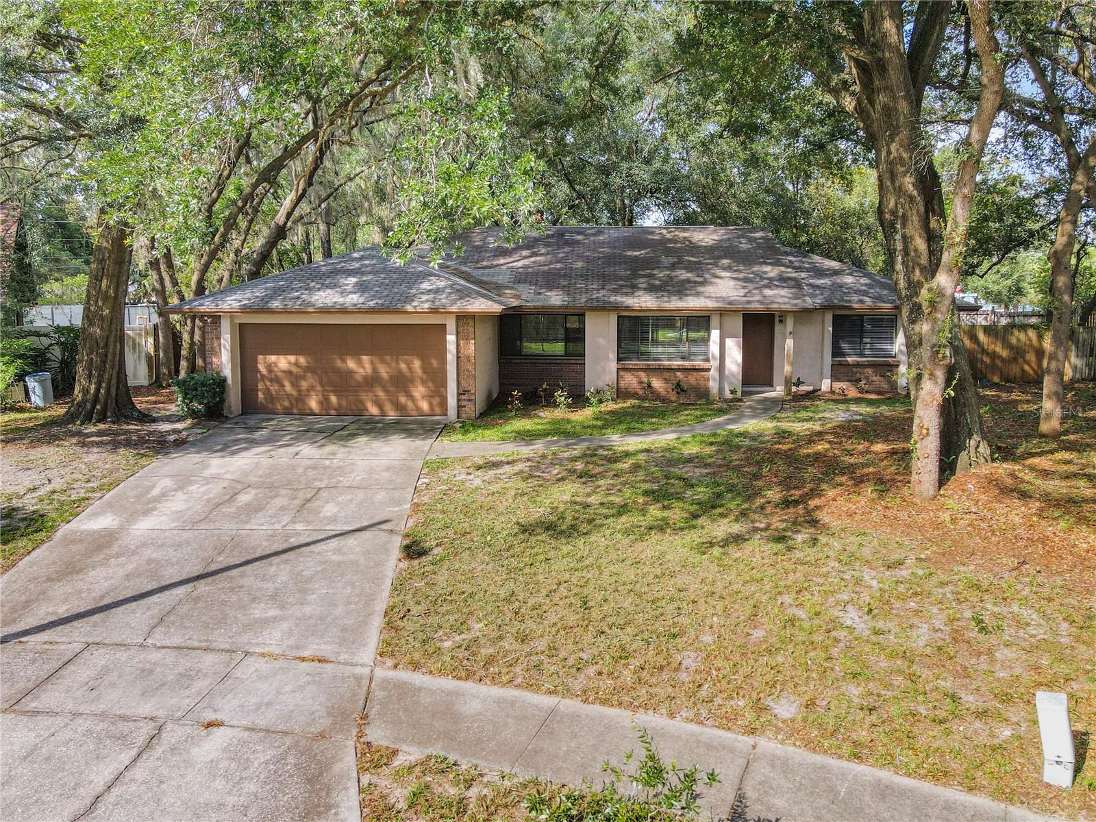 3 Bedroom 2 Bath Split Plan Home sits on a pie shaped .38 acre lot surrounded by oak trees. No HOA. BACK ON THE MARKET! BUYER FINANCING FELL THROUGH! Excellent for move in and upgrade to your taste or an Investment property. As you enter the home the Dining room is straight ahead of you.  The Home's Owners Suite is down the hallway to your left, and is generous in size (for properties constructed in the early 1980's),it also has a Shared Walk in Closet. The Owners Bath area has Dual Sinks and a Shower. The additional Bedrooms on the other side of the home are also generous in size and share a bathroom. The Kitchen has 36 inch cabinets and a Breakfast Bar. The Living Room has a stepdown and is very spacious. The rear of the property can be accessed through the Dining Room Sliding Glass Door and 11'x10' Open Patio. The Fenced Back yard is very large, with oak trees to cover the family during gatherings or enjoy your own quiet time. The A/C is 2023, Hot Water Heater is 2002. NEW ROOF TO BE ADDED PRIOR TO CLOSING. The Price is discounted for Flooring. The Property does need interior upgrades. This was a rental property for the Owners. A 1-year Home Warranty is included with the property.