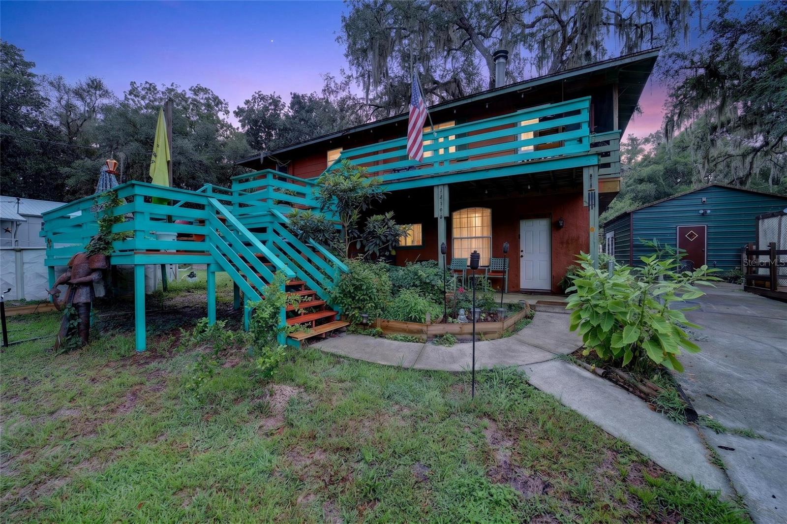 Income-producing opportunity just minutes from the Ocklawaha River and Ocala National Forest! Whether you're searching for a primary residence with supplemental income, a multi-generational property, or a turnkey investment, this unique Fort McCoy property offers exceptional flexibility with multiple finished living spaces and an established short-term rental history.
Situated on a spacious corner lot, the main living area upstairs features an updated kitchen with stainless steel appliances, and ample cabinetry, opening to a welcoming living room with a cozy corner fireplace. Cedar accent walls add warmth and character, while double sliding glass doors lead to a screened porch and adjoining wood deck—perfect for enjoying the peaceful natural surroundings. The upper level also includes two bedrooms and an updated full bathroom with a beautifully tiled walk-in shower.
The lower level has been thoughtfully configured into two finished living spaces, each with its own private entrance. One finished living space includes a living room, kitchen area, bedroom, full bathroom, and utility area, while the second offers a comfortable one-bedroom, one-bath layout with warm wood accents and a charming cabin-like feel that guests are sure to appreciate. These spaces are currently utilized as successful Airbnb and VRBO rentals with an excellent booking history, offering outstanding income potential.
Adding even more value, the former 18' x 20' metal garage has been converted into an additional finished studio living space, complete with electricity and a tankless gas water heater, providing even more flexibility for guests, extended family, hobbies, or potential income opportunities.
Outdoor enthusiasts will appreciate being within walking distance of the community boat ramp on the scenic Ocklawaha River and just minutes from the Ocala National Forest, offering endless opportunities for boating, kayaking, fishing, hiking, hunting, ATV riding, and exploring Florida's natural beauty. A fully fenced area provides space for pets, and an additional storage shed with a covered parking area is ideal for lawn equipment, ATVs, or recreational gear.
Whether you're looking to expand your investment portfolio, offset your mortgage with rental income, or enjoy a versatile property in one of North Central Florida's premier outdoor recreation areas, this one-of-a-kind property is full of possibilities.