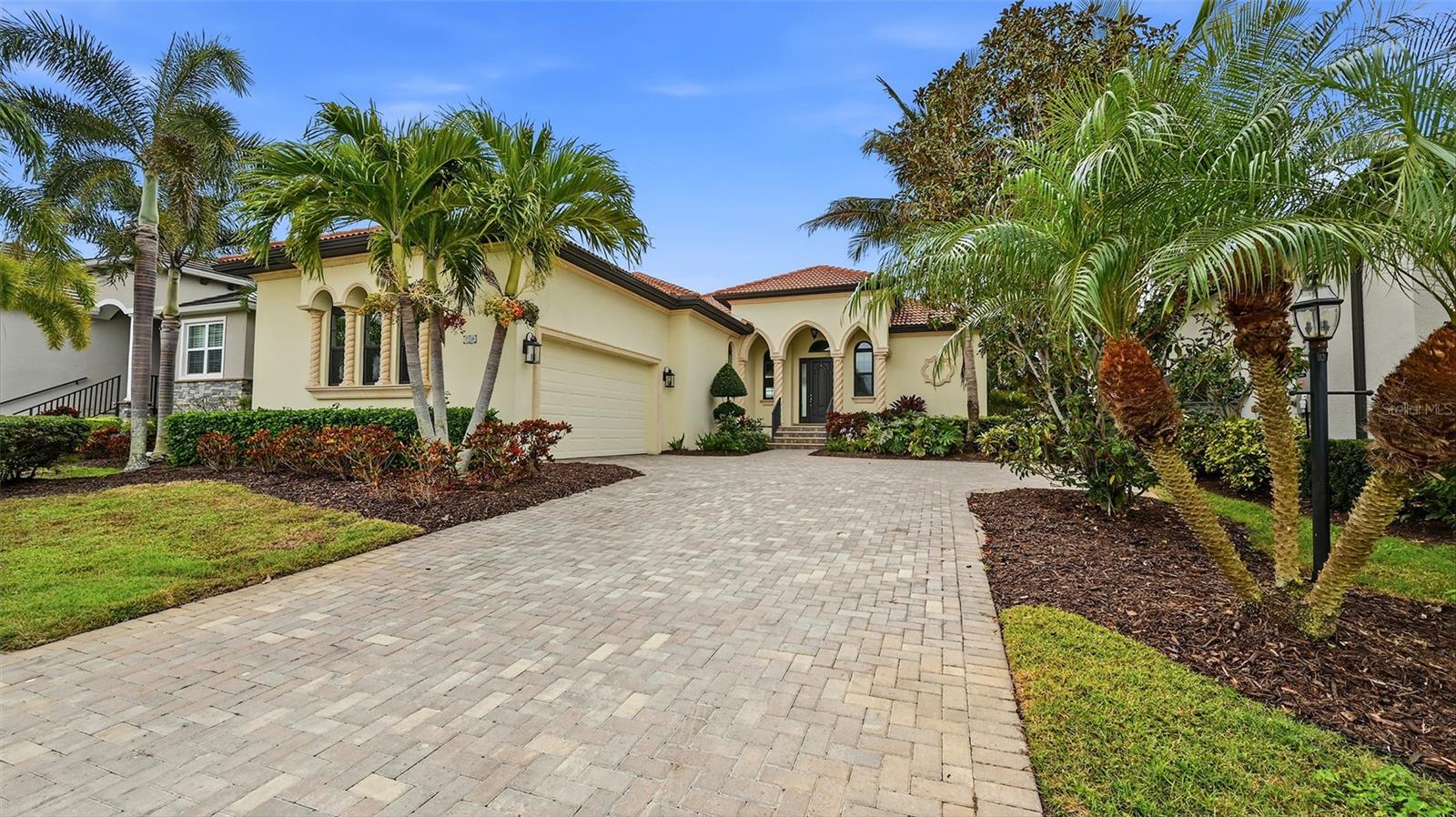 Step into this stunning custom residence in the highly sought after Legends Bay community, where quality construction and thoughtful design come together beautifully. Built by Gibraltar, this home enjoys showcases refined craftsmanship at every turn.
Expansive 12-foot ceilings, elegant tray accents, impact pocketing sliders, and transom windows fill the main living spaces with soft, natural light. Overlooking a peaceful lake, the home offers 3 bedrooms plus a den and a seamless blend of indoor comfort and outdoor enjoyment. Wide plank hardwood flooring, detailed millwork, crown molding, and designer LED fixtures elevate the home’s timeless style.
The chef’s kitchen is both functional and impressive, featuring premium appliances, natural stone countertops, and an oversized island ideal for gatherings. A floor to ceiling walk in pantry adds exceptional storage.
The owner’s suite is a private retreat with serene water views, a spa inspired bath with a soaking tub and walk in shower, and an expansive custom closet. The den provides flexible space for an office, media room, OR quiet lounge.
Outdoors, enjoy a heated pool and spa with smart controls, a covered lanai, and a convenient pool bath—perfect for year round Florida living. The home also includes impact-rated windows and doors and is elevated well above sea level for added peace of mind.
Additional upgrades include oversized garage storage cabinets, automated ceiling mounted storage racks, and an expanded paver driveway accommodating a third vehicle.
Residents of Legends Bay enjoy a lakeside community pool, clubhouse, walking trail, and fishing pier. The HOA includes lawn care and cable/internet. With IMG Golf & Country Club (golf cart friendly), IMG Academy, and the beaches of Anna Maria Island and Longboat Key just minutes away, this home offers an exceptional lifestyle in an unbeatable location.