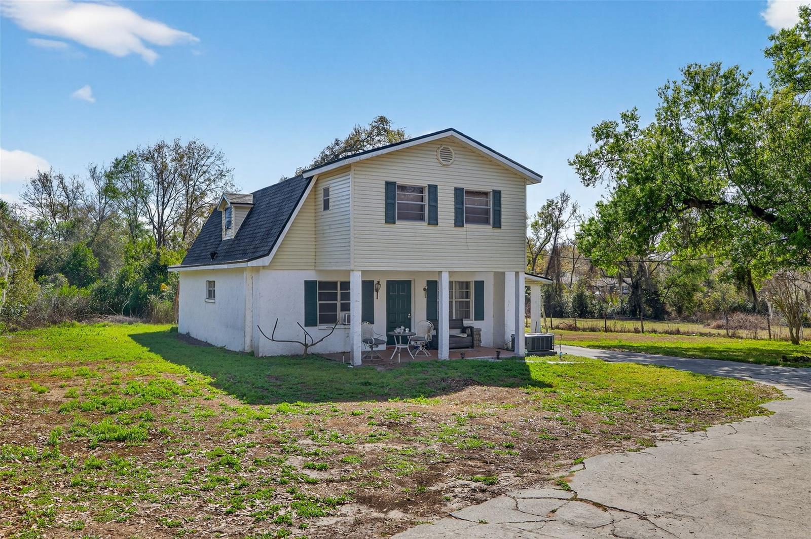 Two Homes on 1.39 Acres in Seffner | Private Road Setting | Mother-in-Law / ADU Opportunity
Rare opportunity to own two detached concrete block homes situated on a 1.39-acre parcel zoned RDC-6 (Residential Duplex Conv.), allowing potential density of up to 6 units per acre. Located about 20 minutes from Tampa, the property offers convenient access to major commuter routes, shopping, dining, and employment centers while maintaining a quiet and private setting accessed via its private road.

With open acreage and a private road setting, the property offers privacy, flexibility, and space to spread out while still remaining close to the city, making it ideal for buyers seeking room for RVs, boats, trailers, or recreational vehicles.

The property features a main residence offering 2 bedrooms and 2 full bathrooms along with a detached 1 bedroom, 1.5 bathroom Mother-in-Law / ADU-style residence. This flexible setup is ideal for multigenerational living, extended family, or living in one residence while generating supplemental rental income from the other.

Main Residence – Rear Home (1,800 SF)
The larger rear residence serves as the primary living space and offers a spacious layout. The first floor features a large primary bedroom with en-suite bathroom, along with the main living area, dining space, open kitchen, and convenient inside laundry. The second level features a generous open bonus area, ideal for an office, media room, or second living space. Also located upstairs are the second bedroom, a full bathroom, and an expansive covered balcony, creating additional flexibility for guests, work-from-home needs, or recreation. The residence also includes covered front and rear porches and a side carport, providing comfortable outdoor living space and additional covered parking. Roof (2022).

Mother-in-Law/ADU-Style Residence – Front (858 SF)
This residence features a one-bedroom layout with the bedroom and en-suite bathroom located on the second floor. The first floor includes a spacious living area, kitchen, separate dining space, half bathroom, and convenient inside laundry. Recently refreshed with new interior paint, updated light fixtures, and new window treatments. Additional features include a covered and fully screened side patio, exterior storage, and a parking pad. Roof (2024).

The 1.39-acre parcel provides open space and flexibility, offering room to spread out while maintaining privacy. Buyers may choose to enjoy multigenerational living, occupy one residence while renting the other, or take advantage of the property’s zoning flexibility and long-term potential. With acreage becoming increasingly limited near Tampa, opportunities offering two residences, privacy, and flexible living arrangements are becoming harder to find. Please do NOT disturb tenant or walk the property without permission. Call today to schedule a showing!