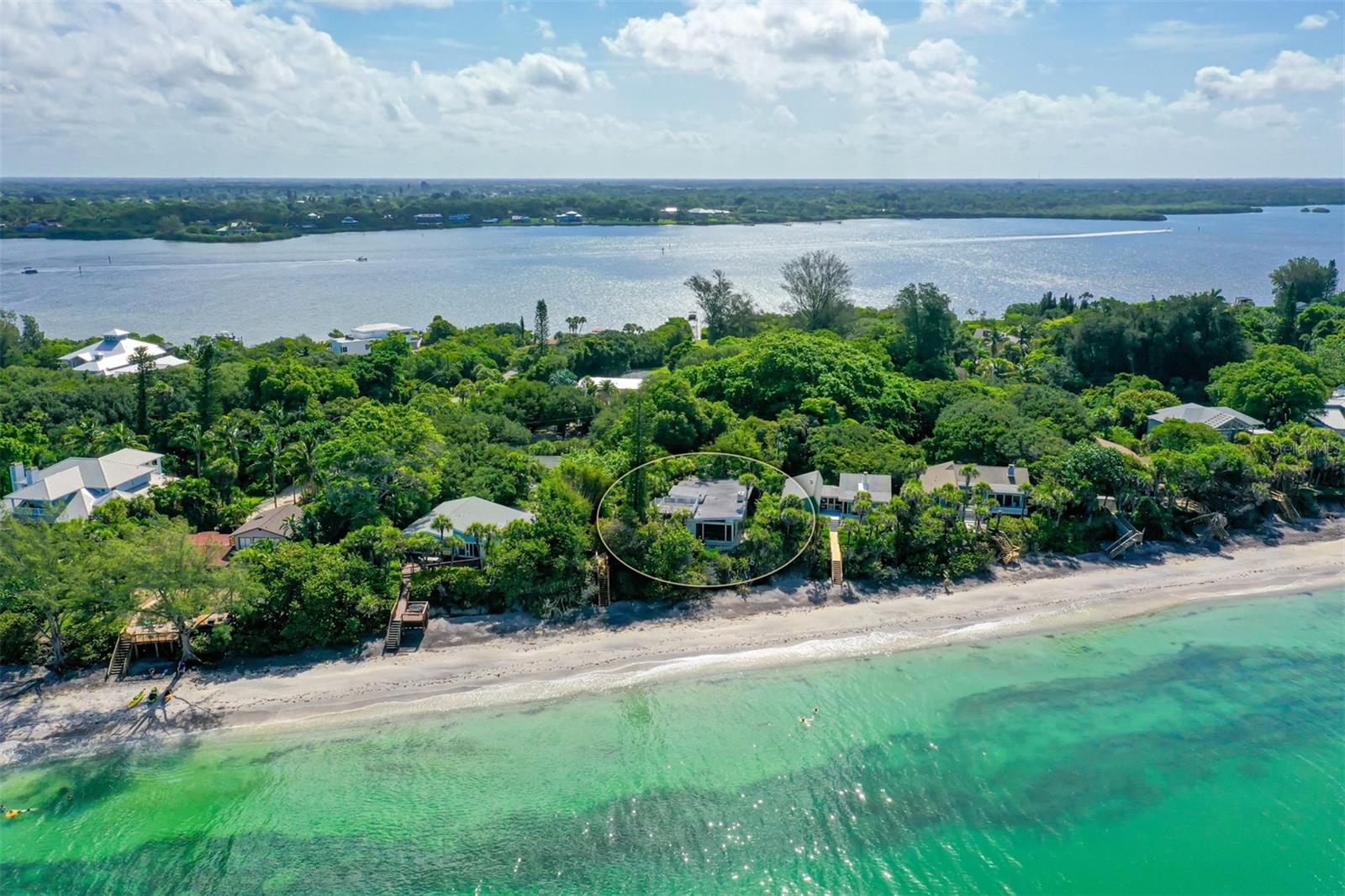 Amazing Sunsets awaits you at this very private tropical paradise.  Lush landscaping and oak trees invite you into this Beach Cottage, Great room with high ceilings and wood burning fireplace, kitchen with Gulf views to enjoy cooking and entertaining. The two Guest Bedrooms are on the lower level with private bath and separate entrance.  Casual and inviting this home captures the beach experience.  The Guest House at 7565 Manasota Key is included, features 3 bedrooms, 2 baths totally renovated with private dock on Lemon Bay.