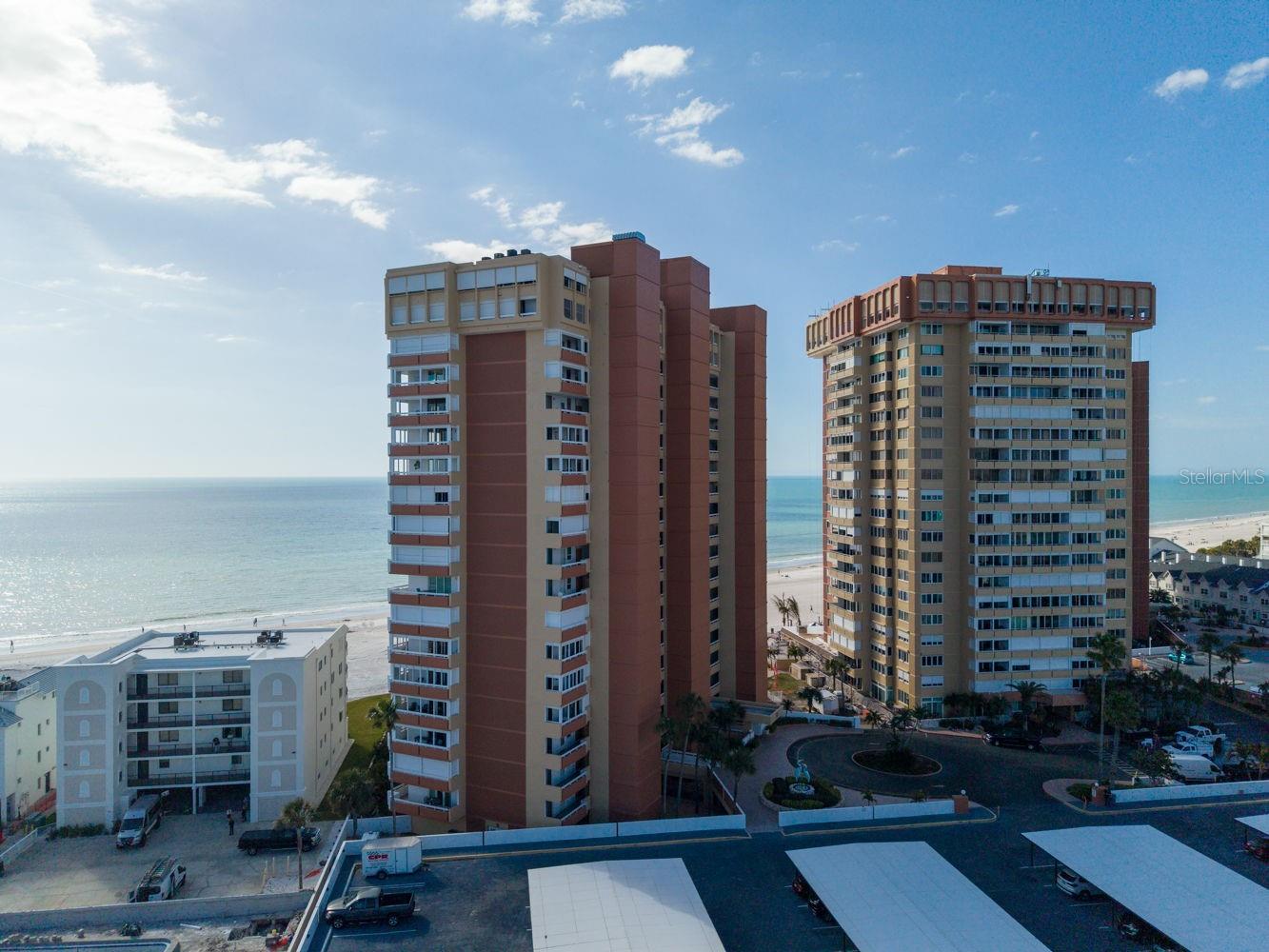 Rarely available and undeniably exceptional, this Gulf-front corner residence in Redington Shores offers a front-row seat to some of the most breathtaking scenery on Florida’s Gulf Coast. With unobstructed views stretching across the Gulf of Mexico and sweeping toward the Intracoastal Waterway, this two-bedroom, two-bath condominium delivers the kind of panoramic coastal experience that few properties can match.

From the moment you step inside, walls of windows wrap the open-concept living and dining spaces in natural light, framing endless blue horizons from nearly every angle. The layout is thoughtfully designed for both relaxed beachside living and effortless entertaining, with sliding glass doors positioned on either side of the living area—creating seamless access to what truly sets this residence apart.

This is one of the rare units in the building offering two separate balconies—a secluded front balcony and an expansive Gulf-front wraparound balcony. The private front balcony, accessed just off the kitchen, captures peaceful Intracoastal views and spectacular sunrises—an ideal setting for morning coffee as boats glide by. On the opposite side, the oversized corner balcony is the true showstopper. With multiple access points from the living room and the primary suite, it provides uninterrupted, front-row views of golden Gulf sunsets and the soothing rhythm of the waves below.

The kitchen blends beauty and functionality with granite countertops, rich wood cabinetry, a wine cooler, and a layout designed to keep you connected to guests and the views beyond. The primary suite serves as a serene retreat, complete with an ensuite bath, grand walk-in closet, and Andersen sliding doors that open directly to the Gulf-front balcony—allowing you to wake up to endless water views and fall asleep to the sound of the ocean.

Recent enhancements add peace of mind and modern convenience, including powered hurricane shutters, a brand-new A/C system (2025), automated window shades (2025), and integrated smart home features with security cameras. Two assigned parking spaces in the lower-level garage and a private ground-floor storage unit provide rare and valuable extras.

Residents enjoy resort-style amenities including a year-round heated pool, private beach access, and 24/7 security—creating a secure, effortless coastal lifestyle.

Opportunities like this are few and far between. Whether you’re seeking a full-time beachfront residence, a luxurious vacation escape, or a premium investment property, this exceptional corner unit captures the very essence of Gulf-front living.