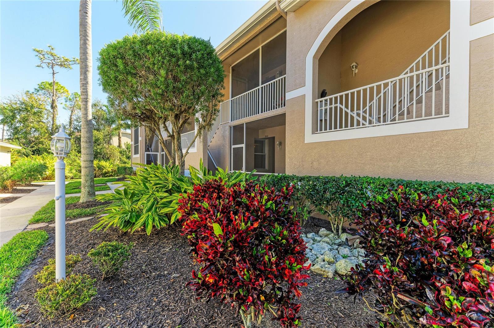 Welcome to this beautifully updated Barrington condominium in the pristine Heritage Oaks Golf & Country Club, where golf and social membership are included. $5,500 CREDIT TOWARDS CLOSING COSTS! This desirable first-floor residence offers 2 bedrooms, 2 bathrooms, and a versatile flex room, ideal for a home office, den, or additional living space. Light and inviting, the condo features new LUXURY VINYL PLANK flooring throughout (installed 01/26) paired with designer lighting, creating a fresh, modern aesthetic. The updated eat-in kitchen is both stylish and functional, showcasing quartz countertops, Whirlpool appliances, and a glass tile backsplash, perfectly suited for everyday living and entertaining. The open-concept floor plan is filled with natural light and flows effortlessly through the living and dining areas. Sliding glass doors open to a covered, screened-in patio, where you’ll enjoy tranquil lake views and sweeping vistas of the 14th fairway, an ideal setting for morning coffee or relaxed evenings with friends. An extended one-car garage provides ample space for golf clubs, beach gear, and additional storage. Heritage Oaks is a bundled private golf community featuring an 18-hole championship course, resort-style pools, clubhouse with dining, fitness center, tennis, pickleball, and a vibrant social calendar—all included with ownership. Ideally located near shopping, dining, and top-rated medical facilities. Just a 25-minute drive to the world-renowned Siesta Key Beach. Whether you’re seeking a full-time residence, seasonal retreat, or income-producing property, this condo delivers the best of Florida living in a welcoming, gated community. Schedule your showing now.