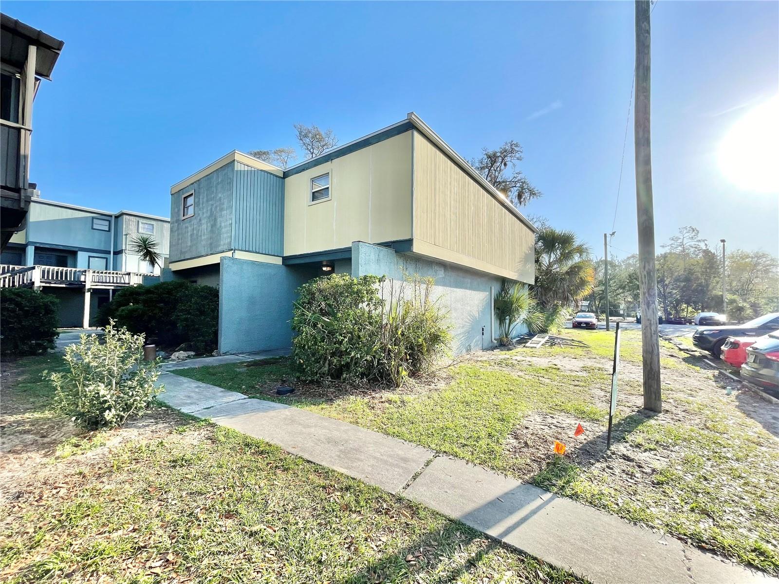 Great buy for a large condo in SW Gainesville! Take a look at this 2 bedroom 2 bath ground floor, corner unit. Both bedrooms are upstairs. Primary bedroom is huge and has 2 walk-in closets, a balcony and a private bathroom with updated shower. The guest bedroom is also large, has a balcony and has a walk-in closet and a bathroom adjacent to it. New water heater recently installed. Laminate flooring in the great room, stairs and bedrooms. Fenced rear patio area. Community has a pool, tennis court, basketball court, clubhouse with fitness room & more. HOA also takes care of building insurance, water, exterior maintenance and trash. Currently leased at $1,175 per month until May 2027.